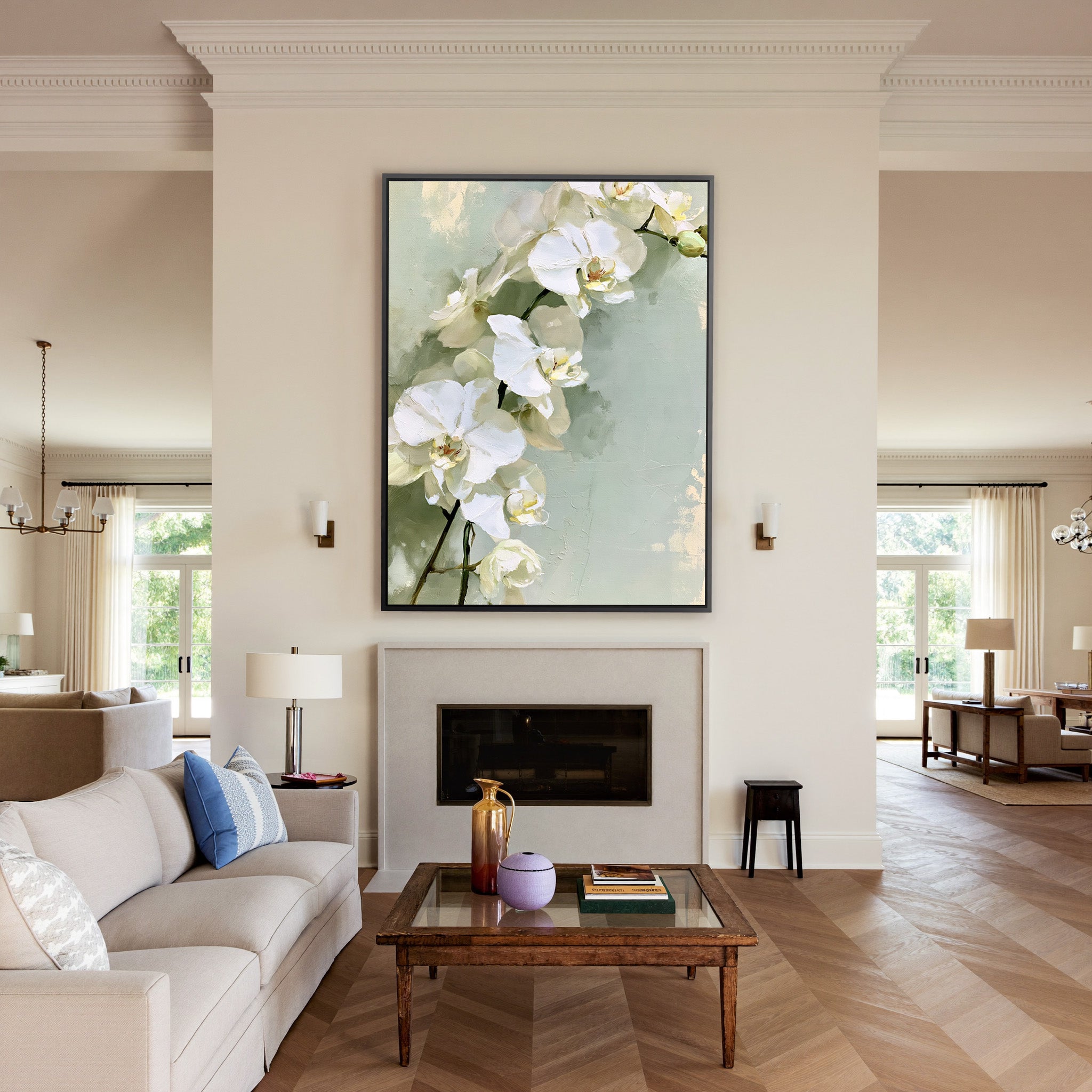 white orchids with long stems on a pale green canvas wall art in a black frame above a mantel