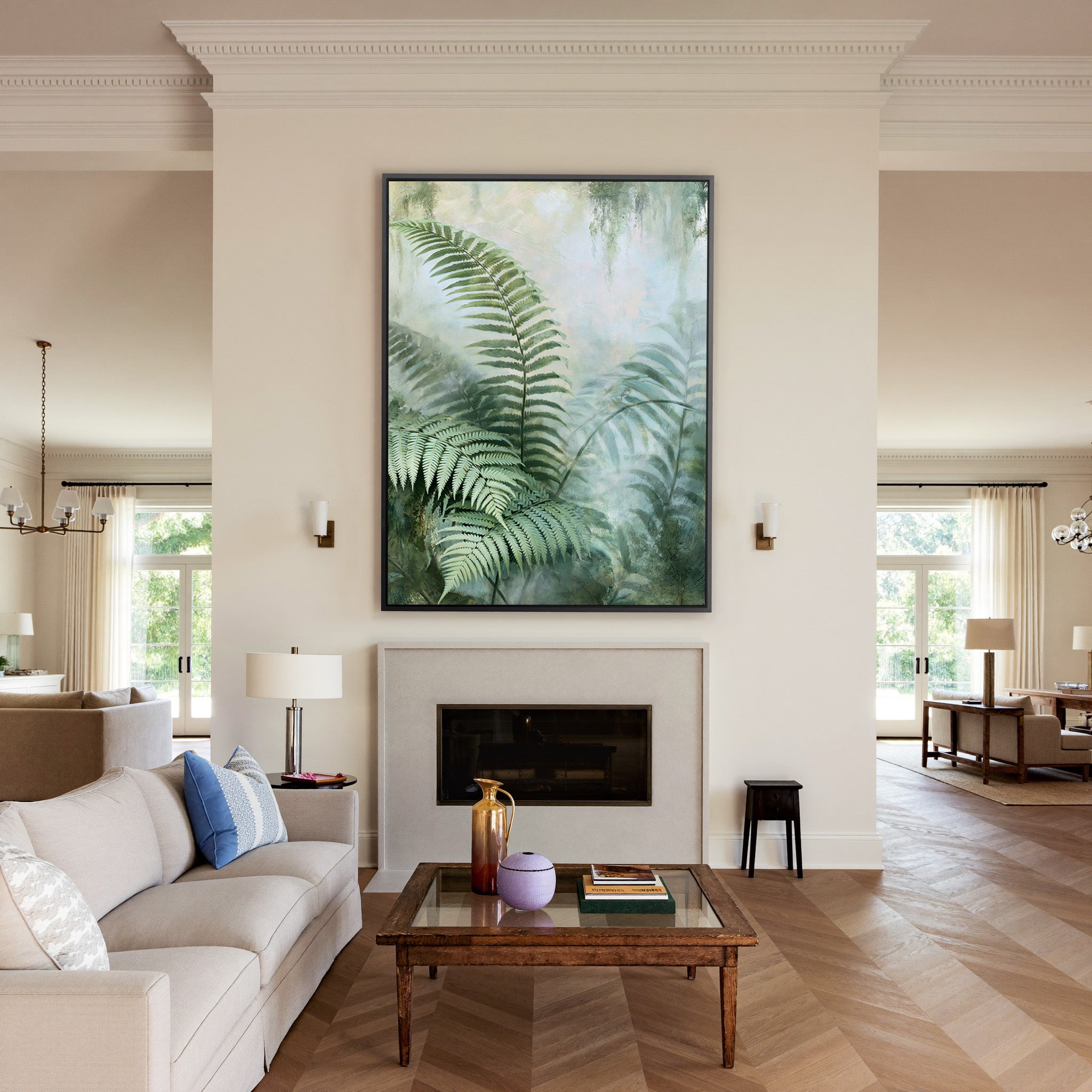 layered green fern fronds in a misty pale canvas wall art in a black frame above a mantel