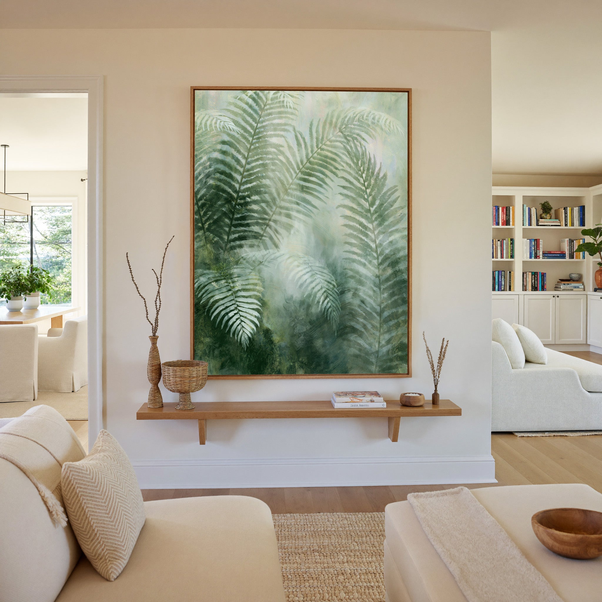 soft green fern fronds over a misty pale ground canvas wall art in an oak frame in a living room