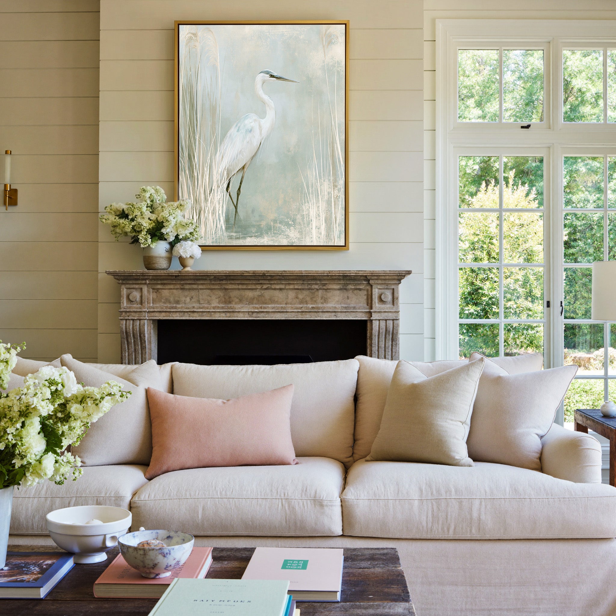 white heron among pale marsh reeds canvas wall art in a gold frame above a mantel