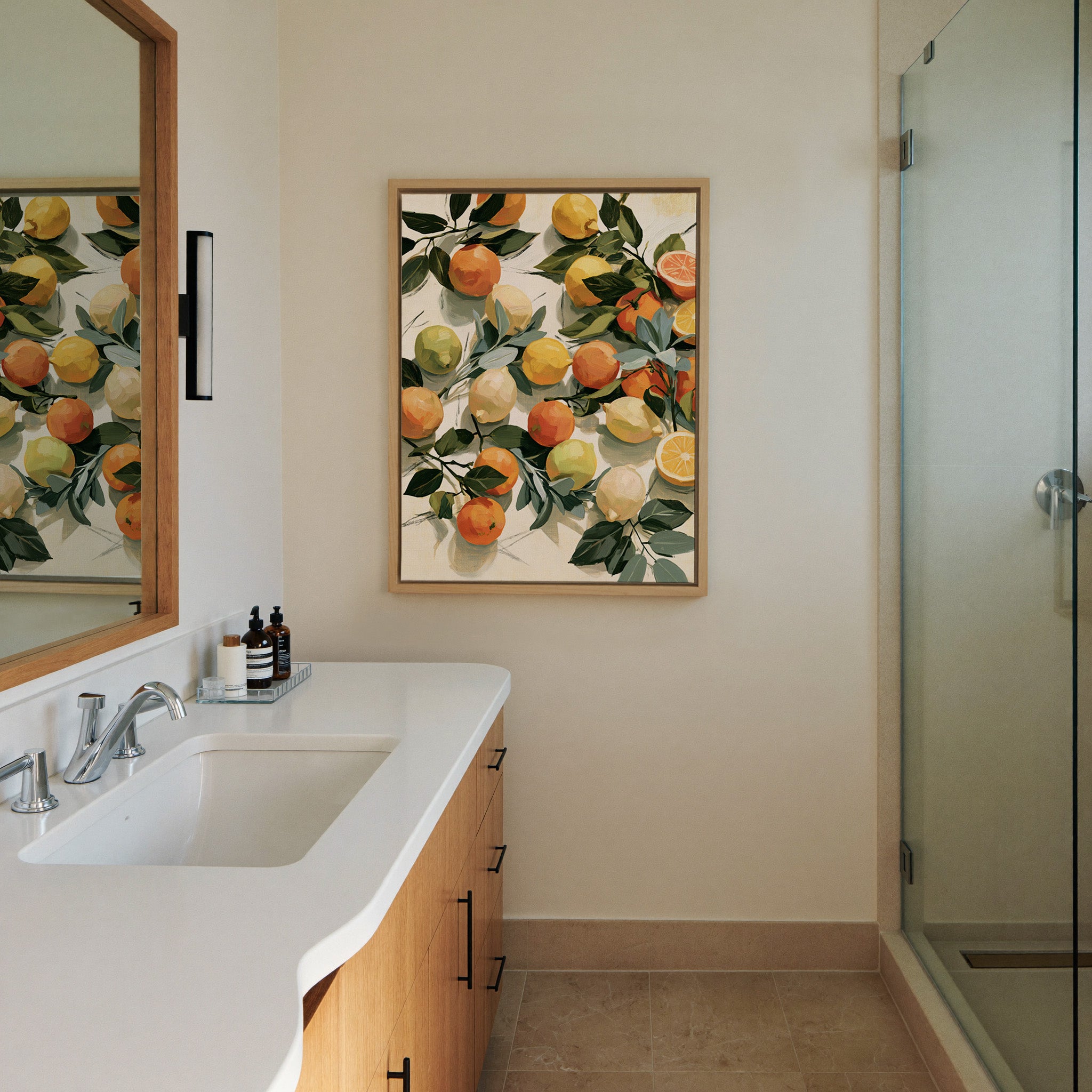 loose citrus still life with dark canvas wall art in a natural wood frame in a styled room setting