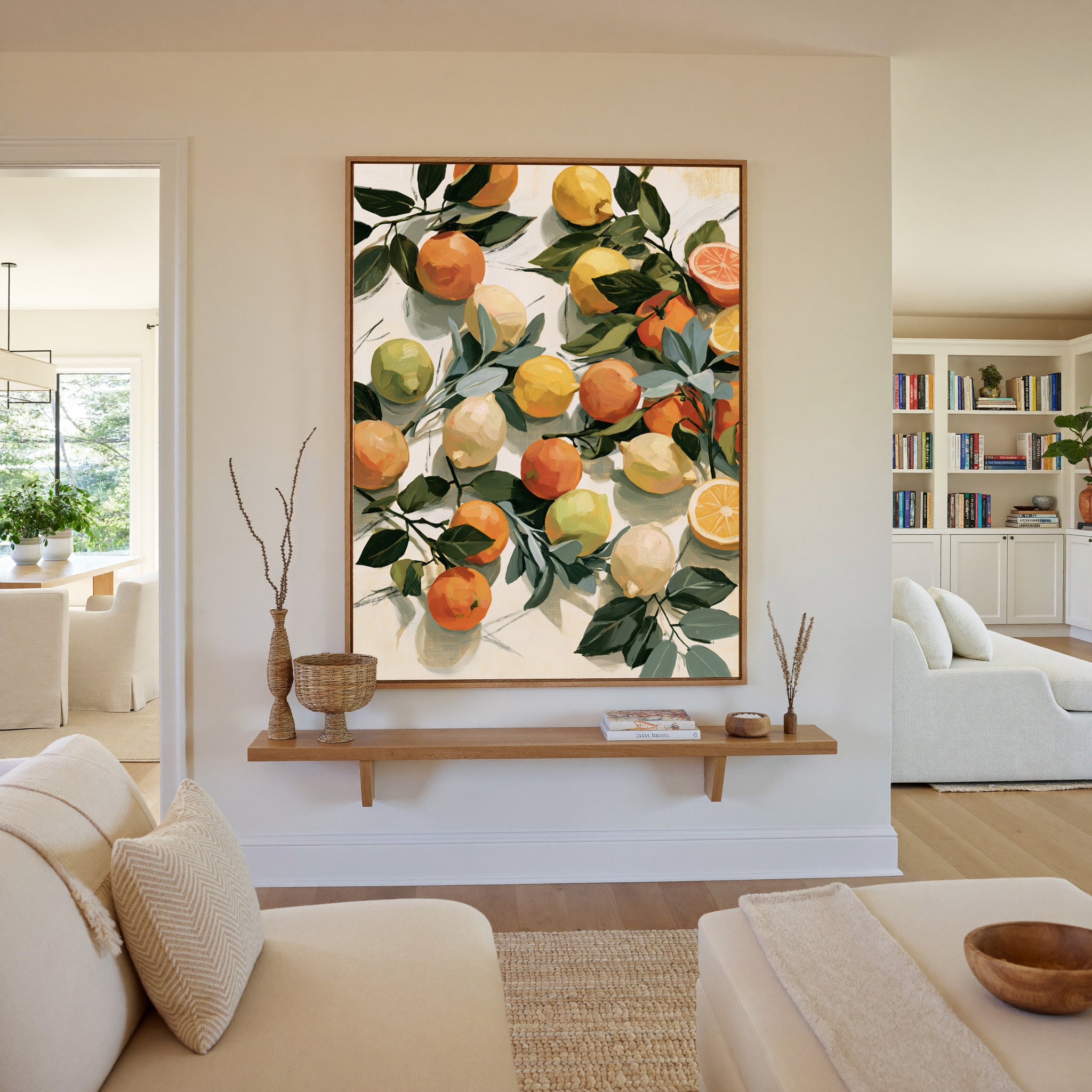 loose citrus still life with dark green leaves canvas wall art in an oak frame in a living room