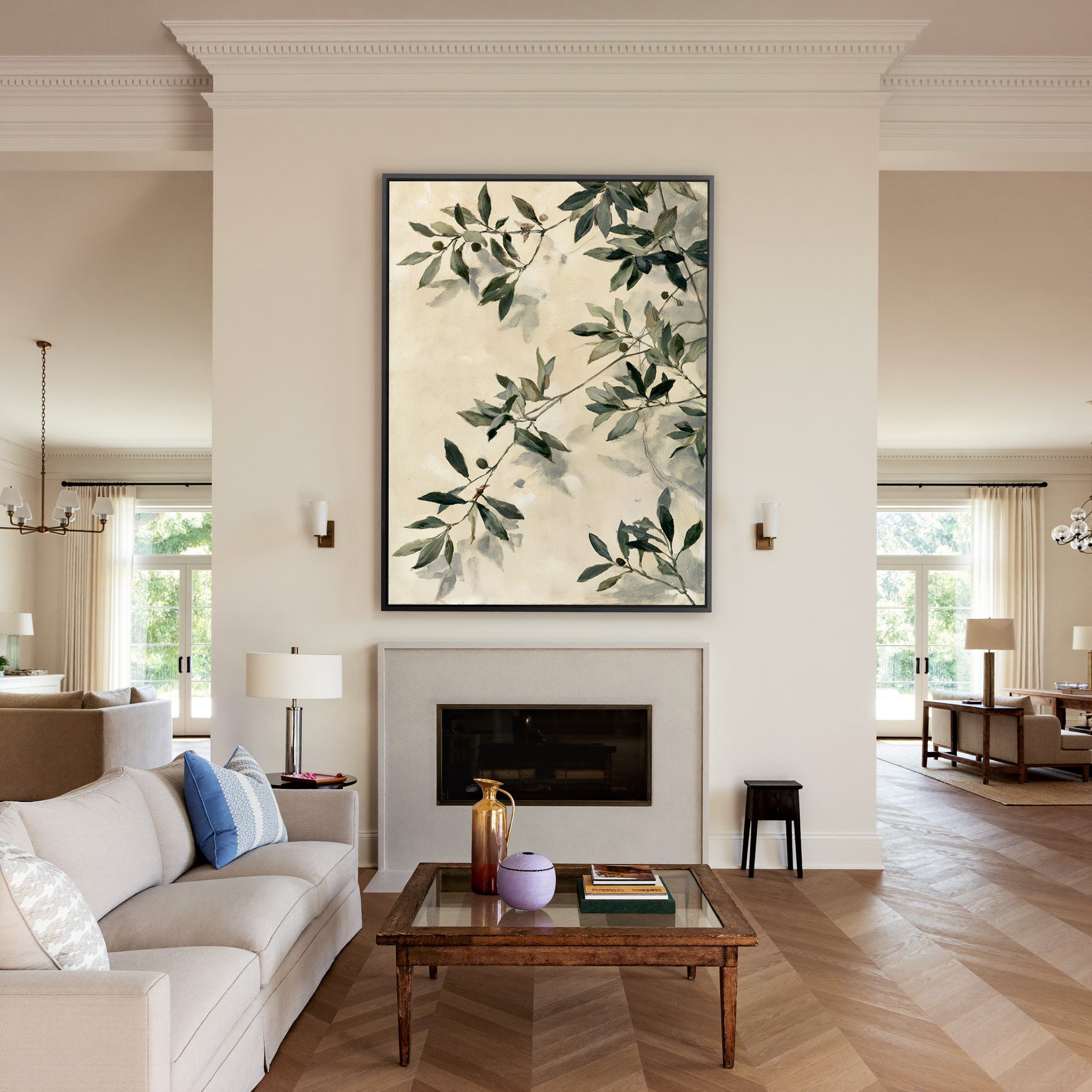 olive branches with soft sage and deep green canvas wall art in a black frame above a mantel