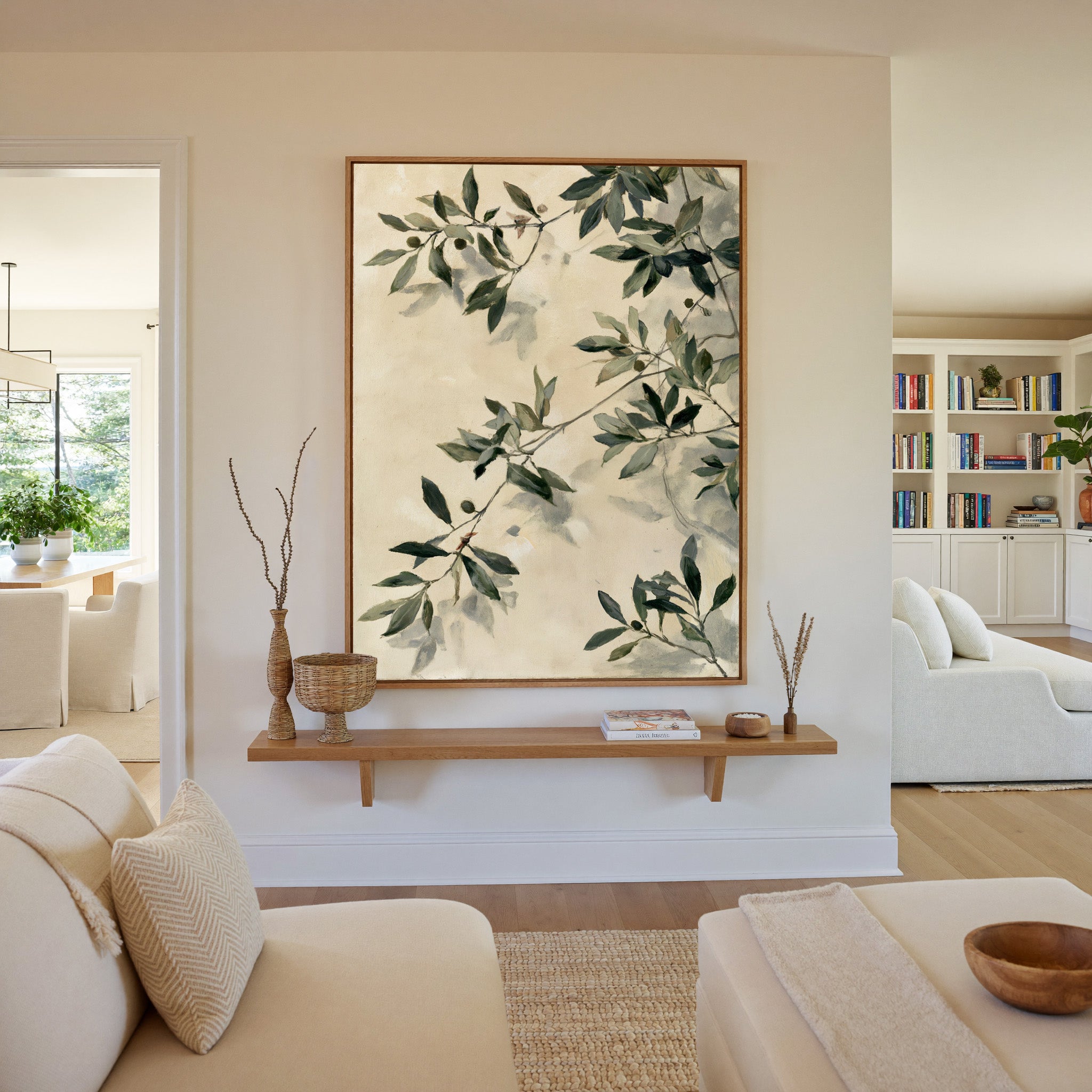 olive branches with soft sage and deep green canvas wall art in an oak frame in a living room
