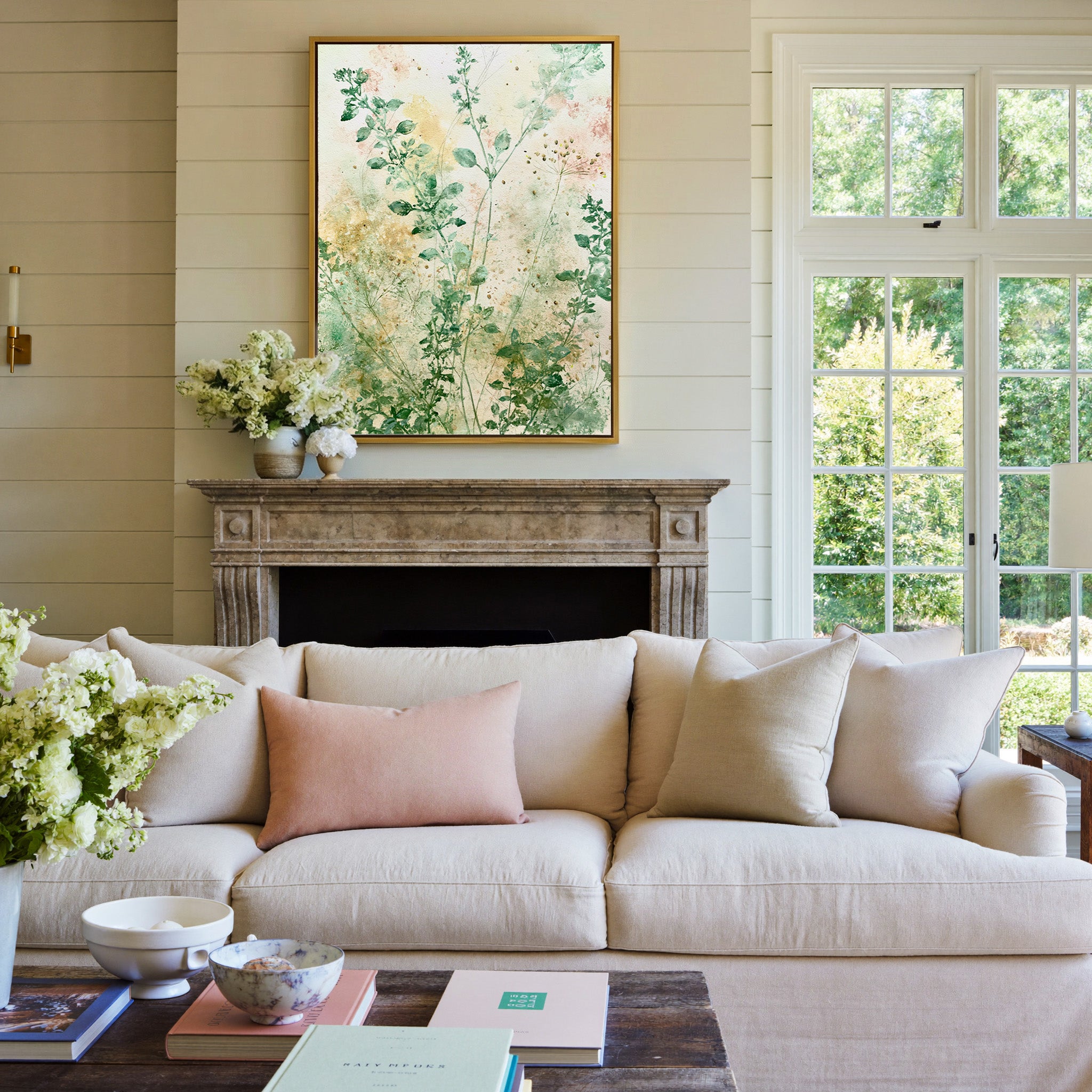 loose herb like stems in sage, cream, and blush canvas wall art in a gold frame above a mantel