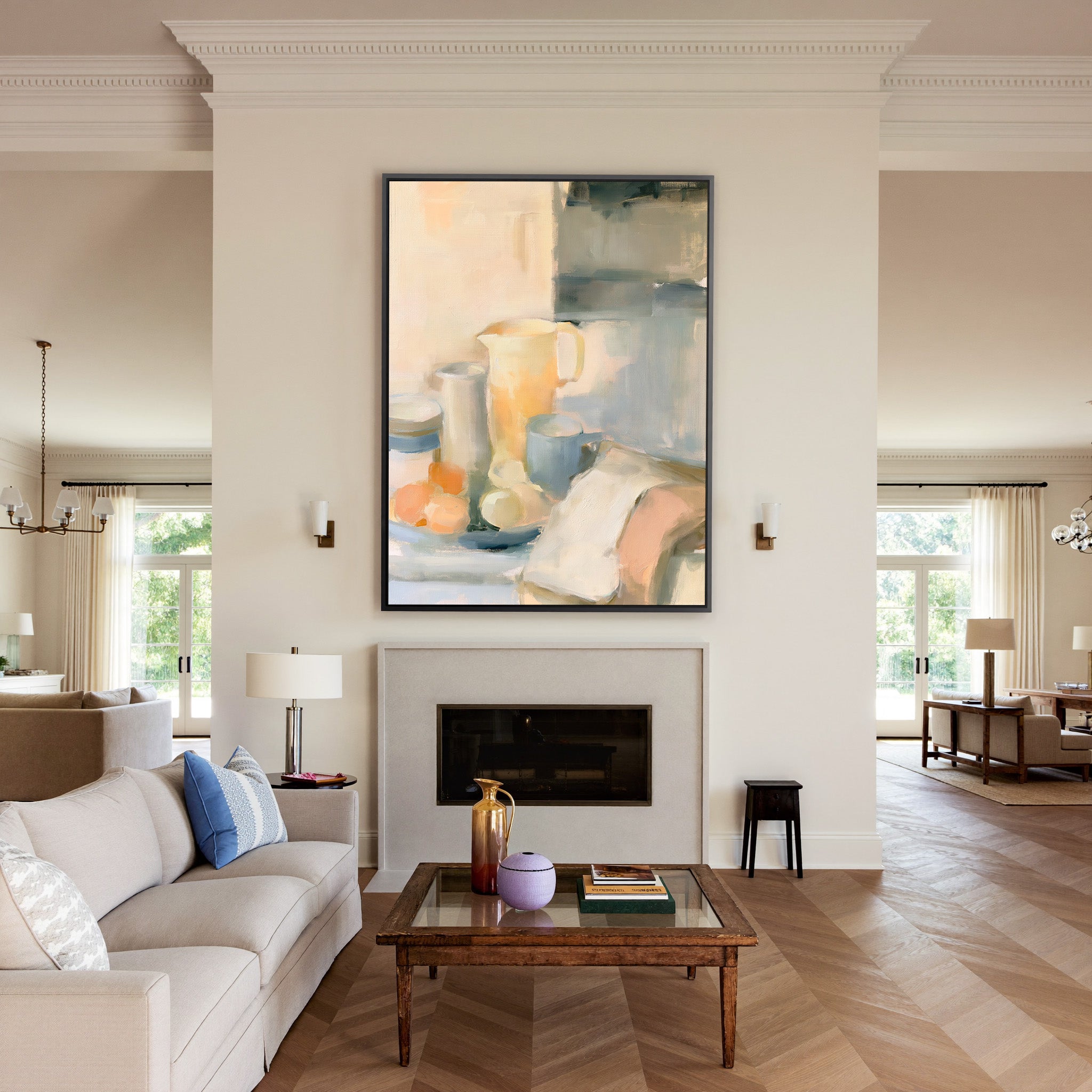 soft neutral still life with pitcher, cups, and canvas wall art in a black frame above a mantel