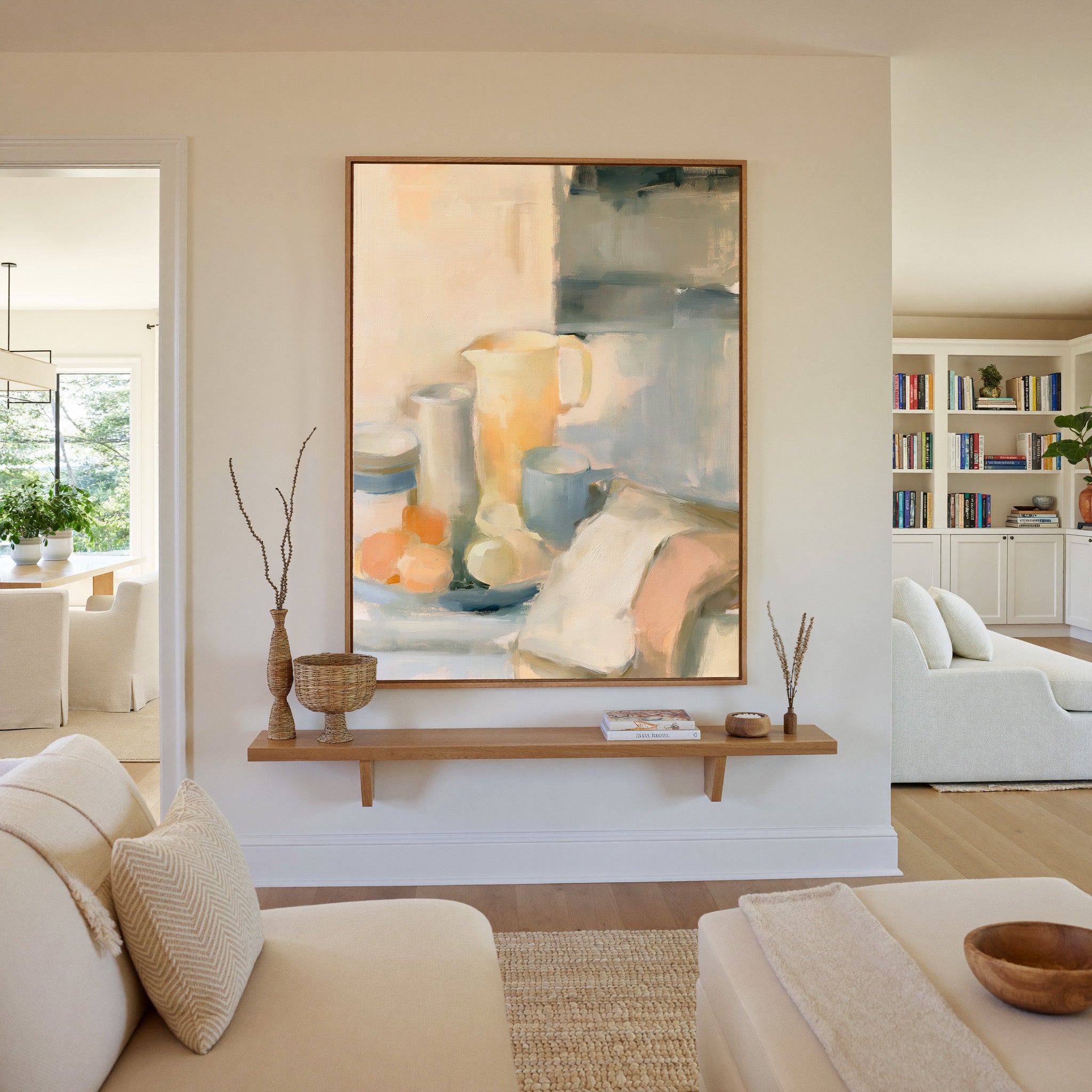 soft neutral still life with pitcher, cups, and canvas wall art in an oak frame in a living room