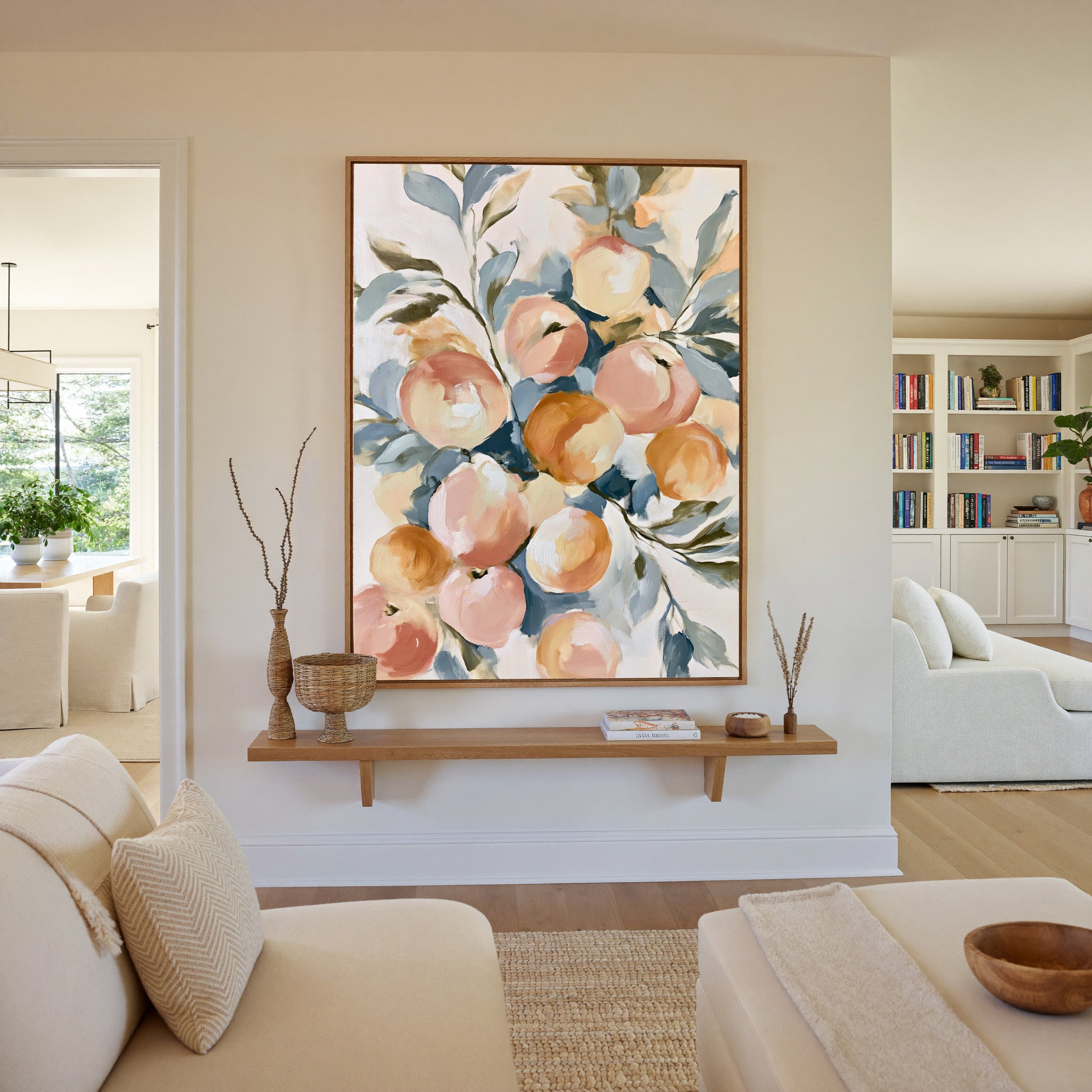 soft peaches and apricots with blue green leaves canvas wall art in an oak frame in a living room