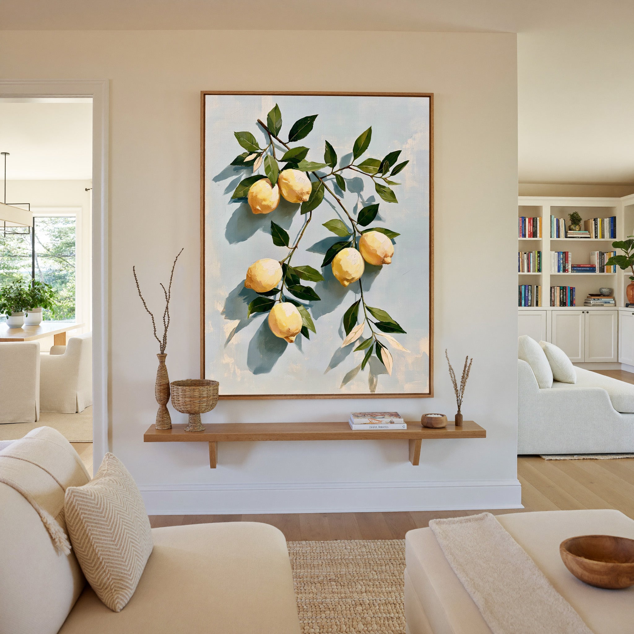 muted lemons with olive leaves on a pale blue canvas wall art in an oak frame in a living room