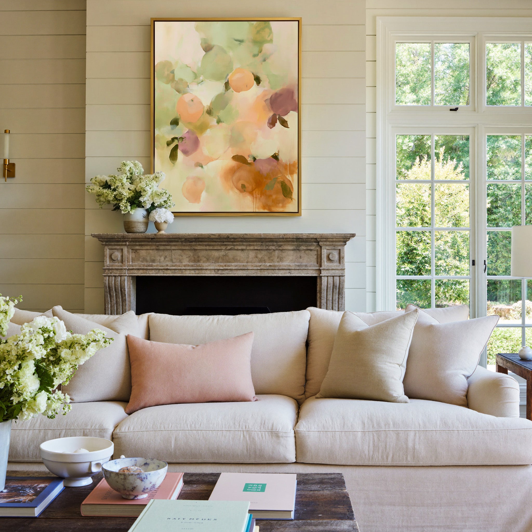 soft orchard toned abstract with pale green, canvas wall art in a gold frame above a mantel