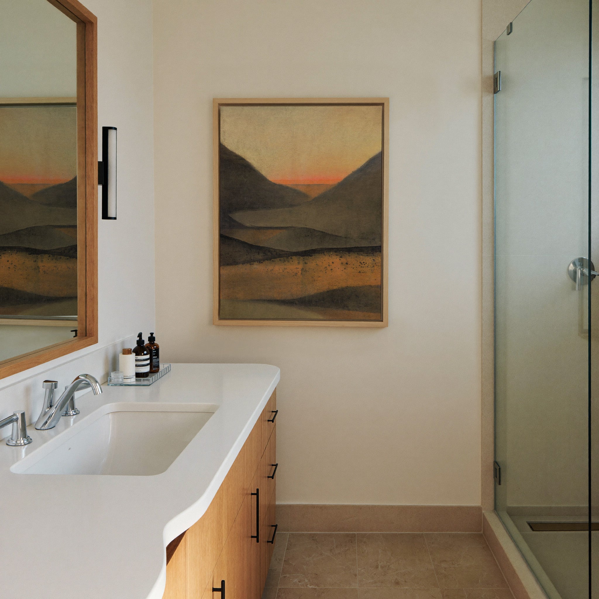 dark mountain landscape with a narrow orange canvas wall art in a natural wood frame in a styled room setting
