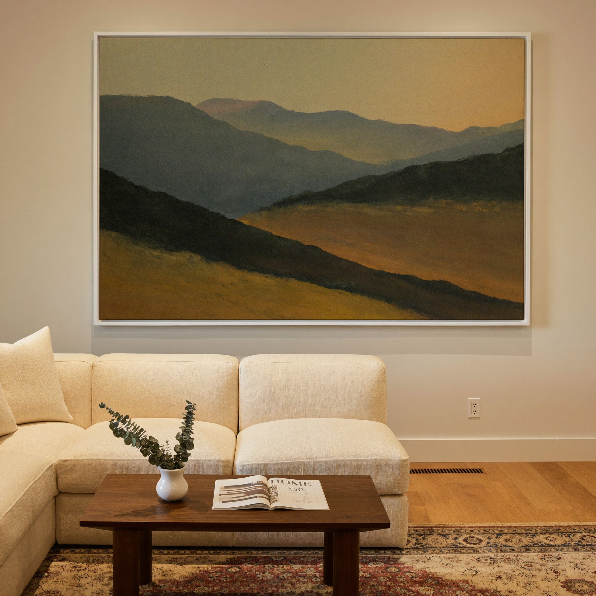layered mountain ridges at sunset canvas wall art in a white frame in a styled room setting
