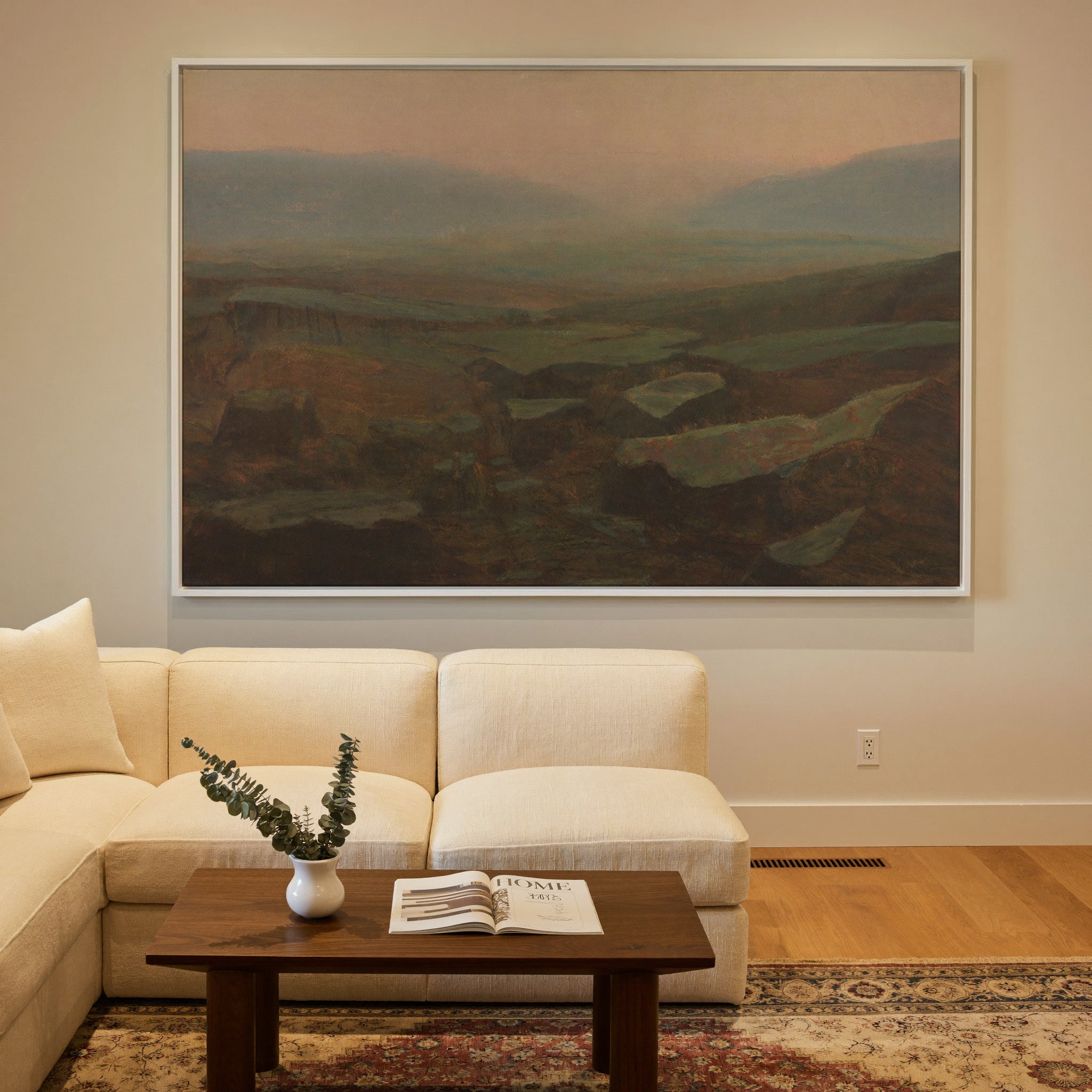 soft canyon landscape with layered mesas and a canvas wall art in a white frame in a styled room setting