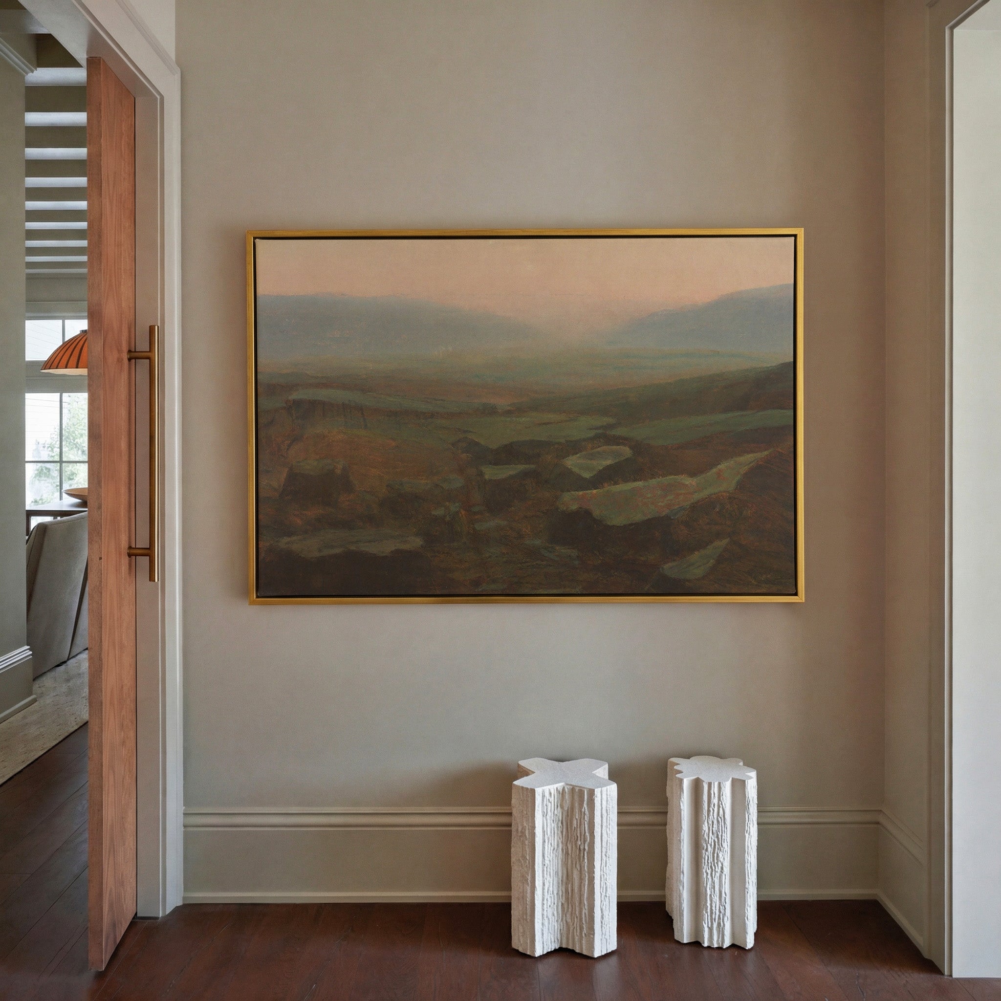 soft canyon landscape with layered mesas and a canvas wall art in a gold frame in a styled room setting
