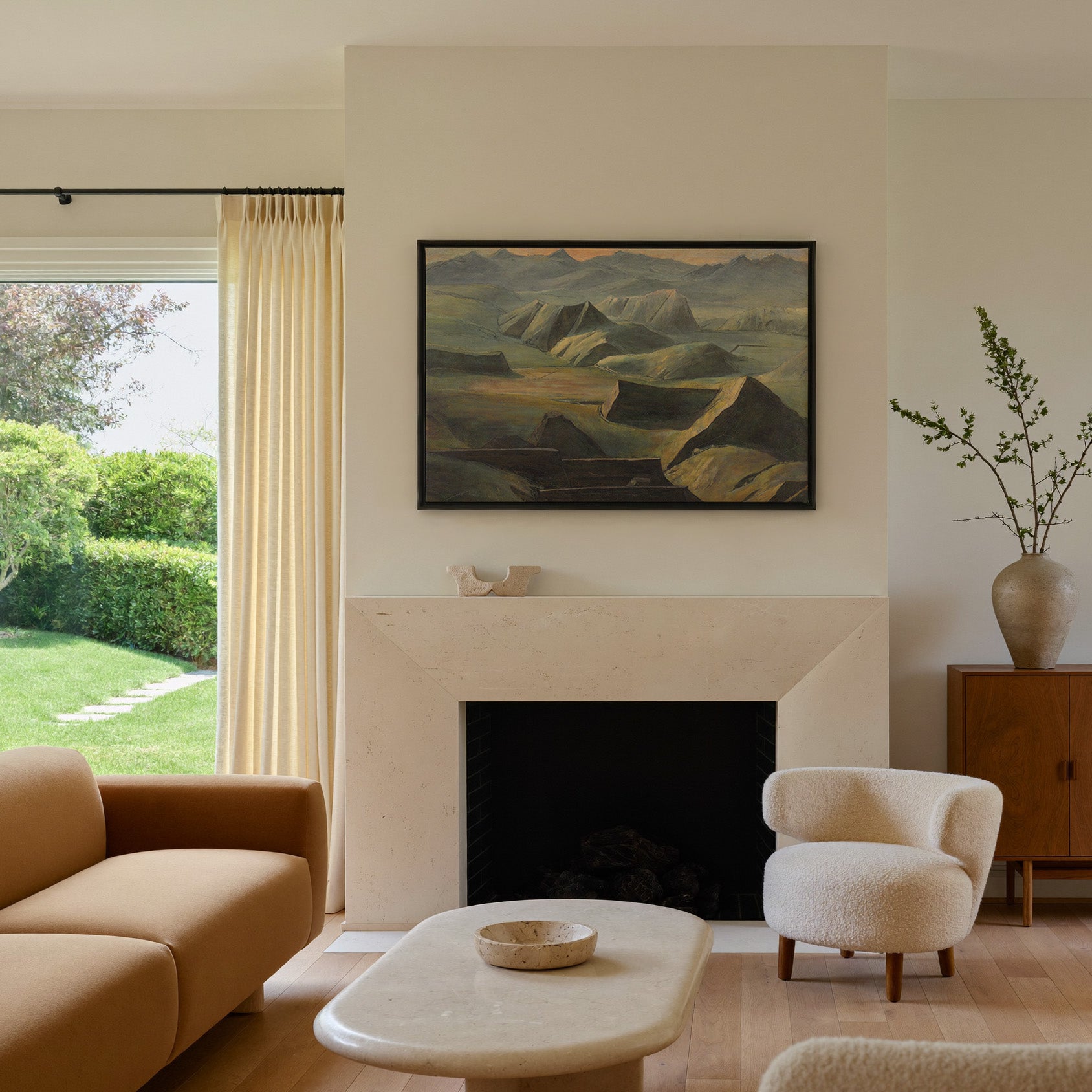 layered mountain ridges with copper light canvas wall art in a black frame above a mantel