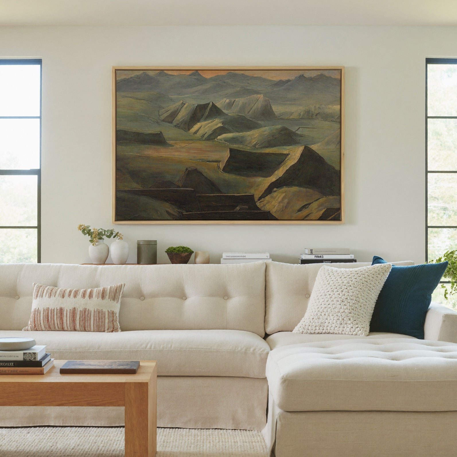 layered mountain ridges with copper light canvas wall art in a natural wood frame in a living room