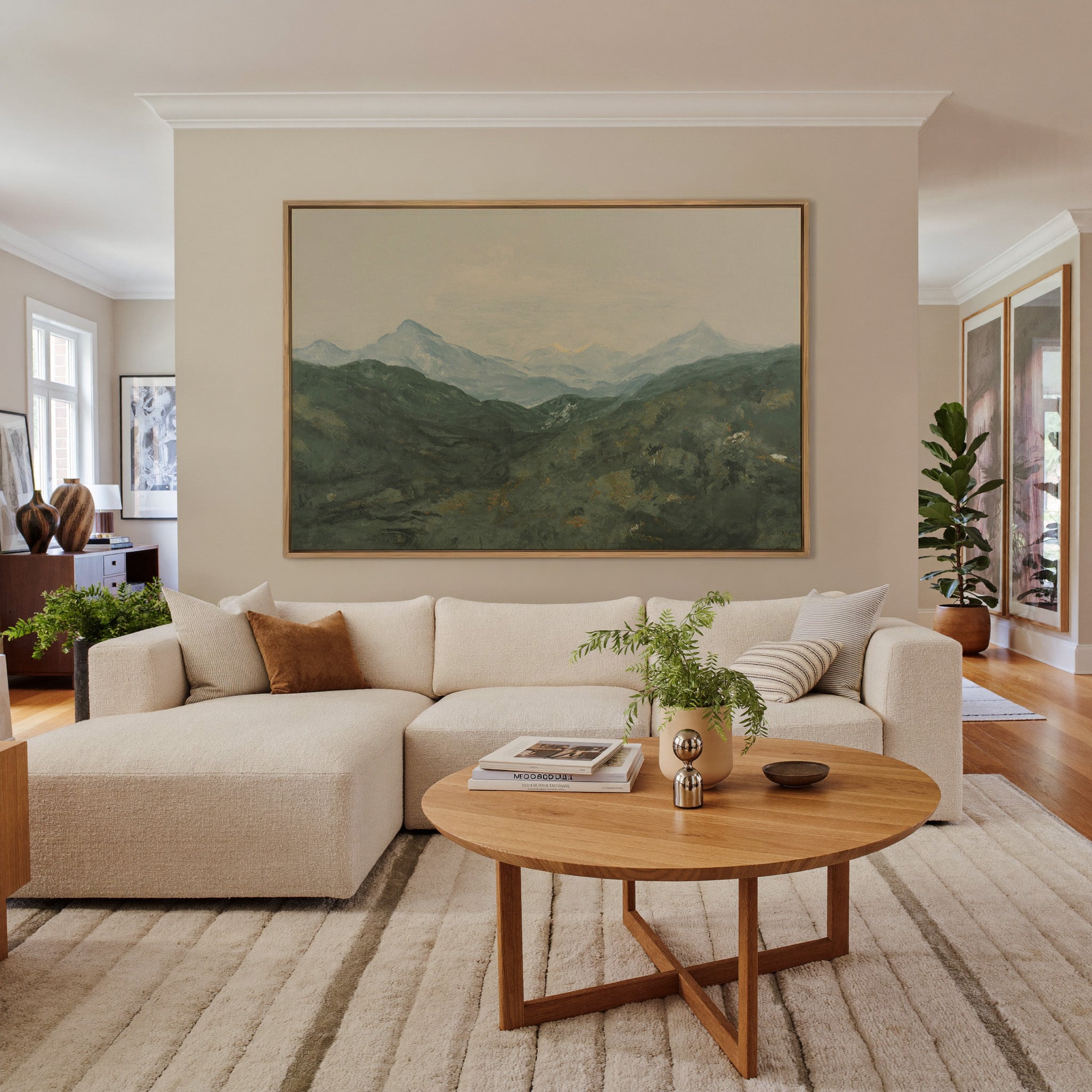 soft green mountain landscape with pale peaks canvas wall art in an oak frame in a living room