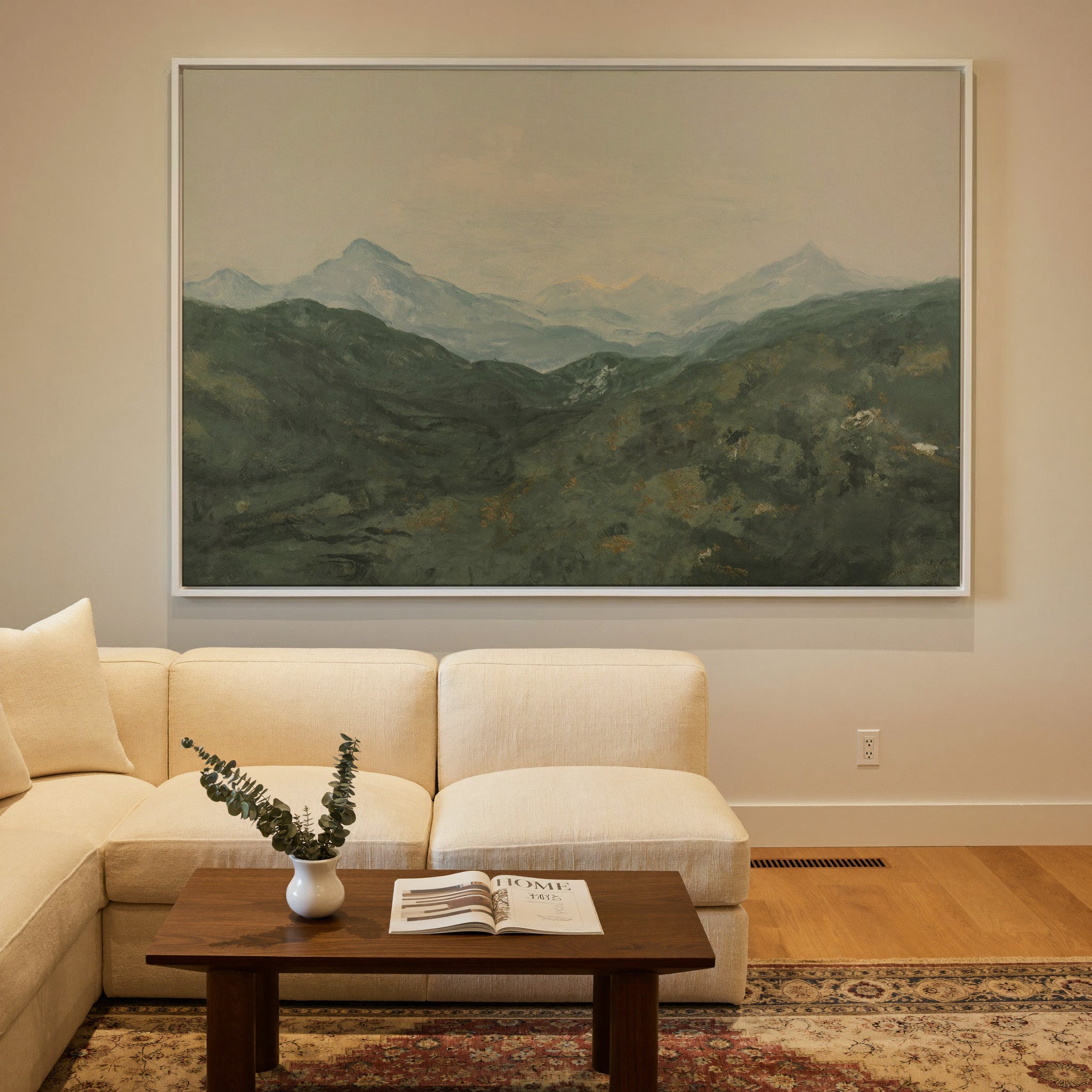 soft green mountain landscape with pale peaks canvas wall art in a white frame in a styled room setting