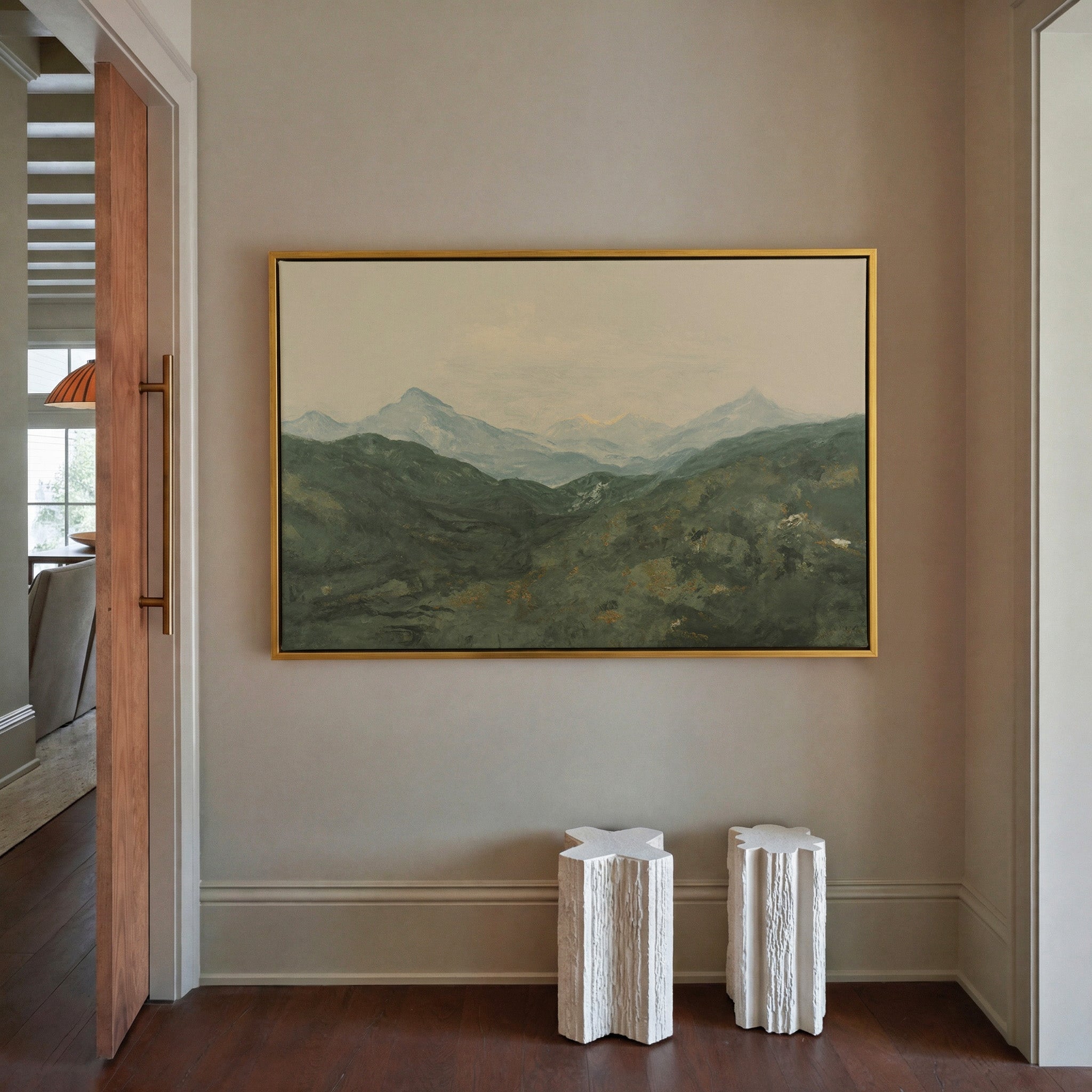 soft green mountain landscape with pale peaks canvas wall art in a gold frame in a styled room setting