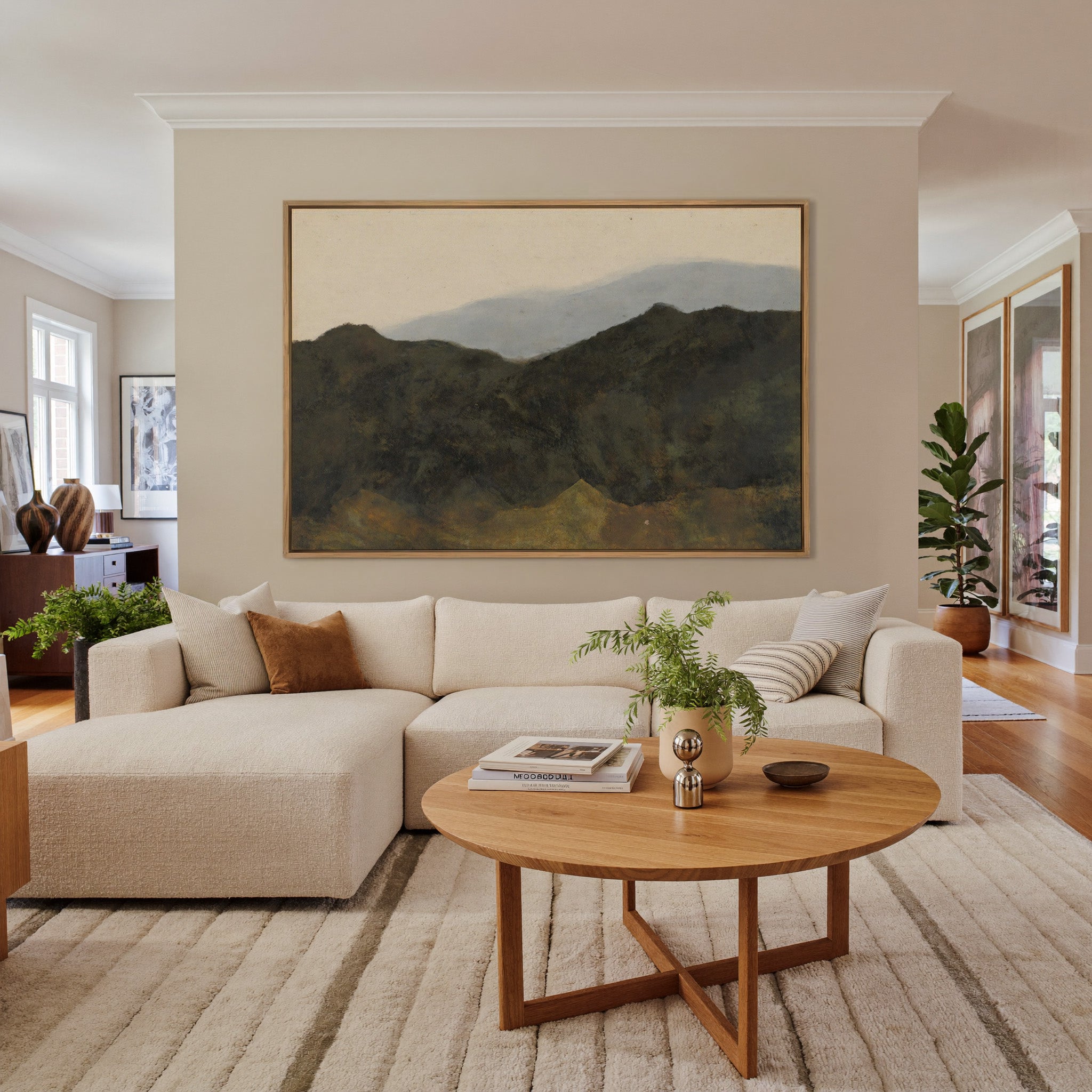 dark mountain ridges beneath a pale hazy sky canvas wall art in an oak frame in a living room