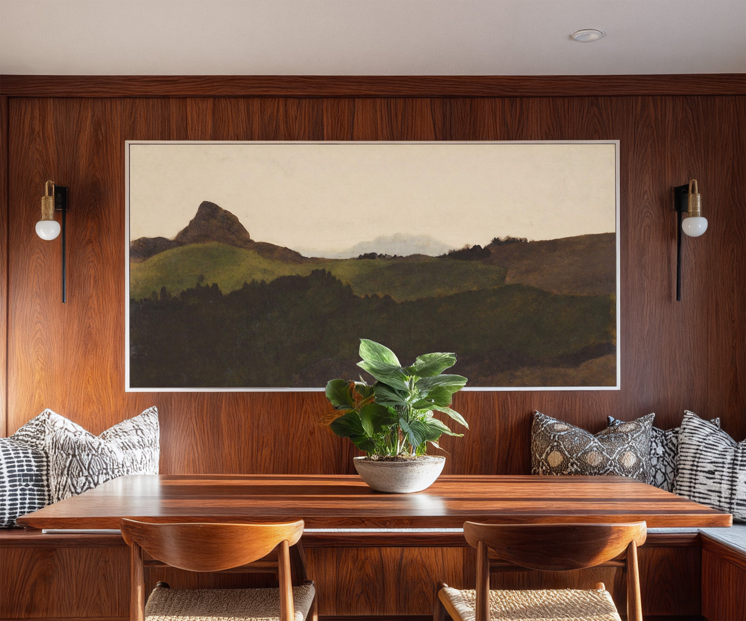 dark green hills with a pale distant peak canvas wall art in a white frame in a styled room setting