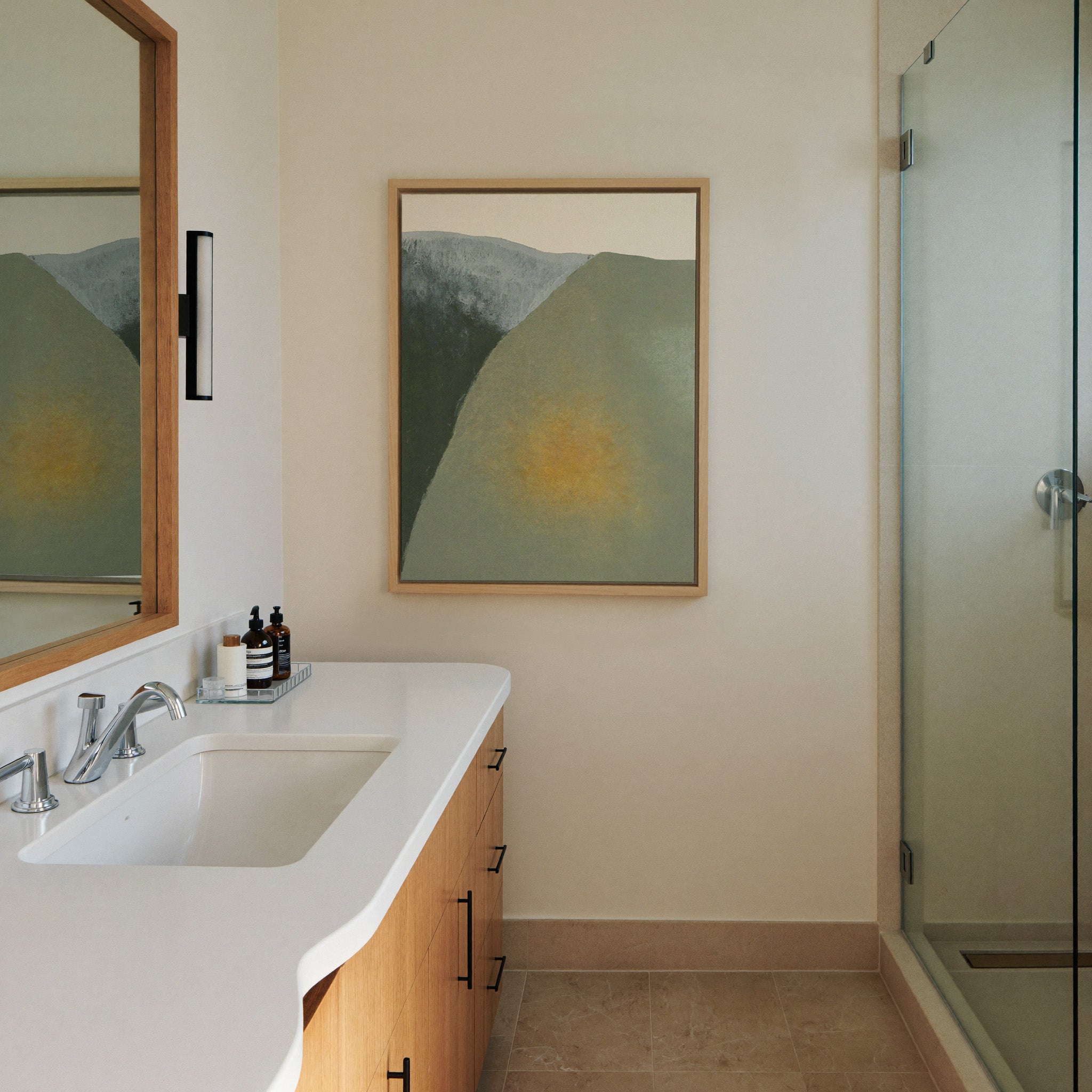 soft olive and charcoal abstract with a warm canvas wall art in a natural wood frame in a styled room setting
