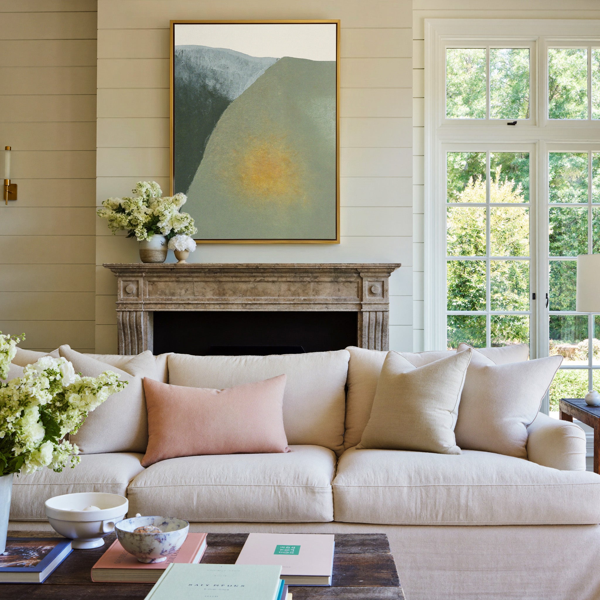 soft olive and charcoal abstract with a warm canvas wall art in a gold frame above a mantel