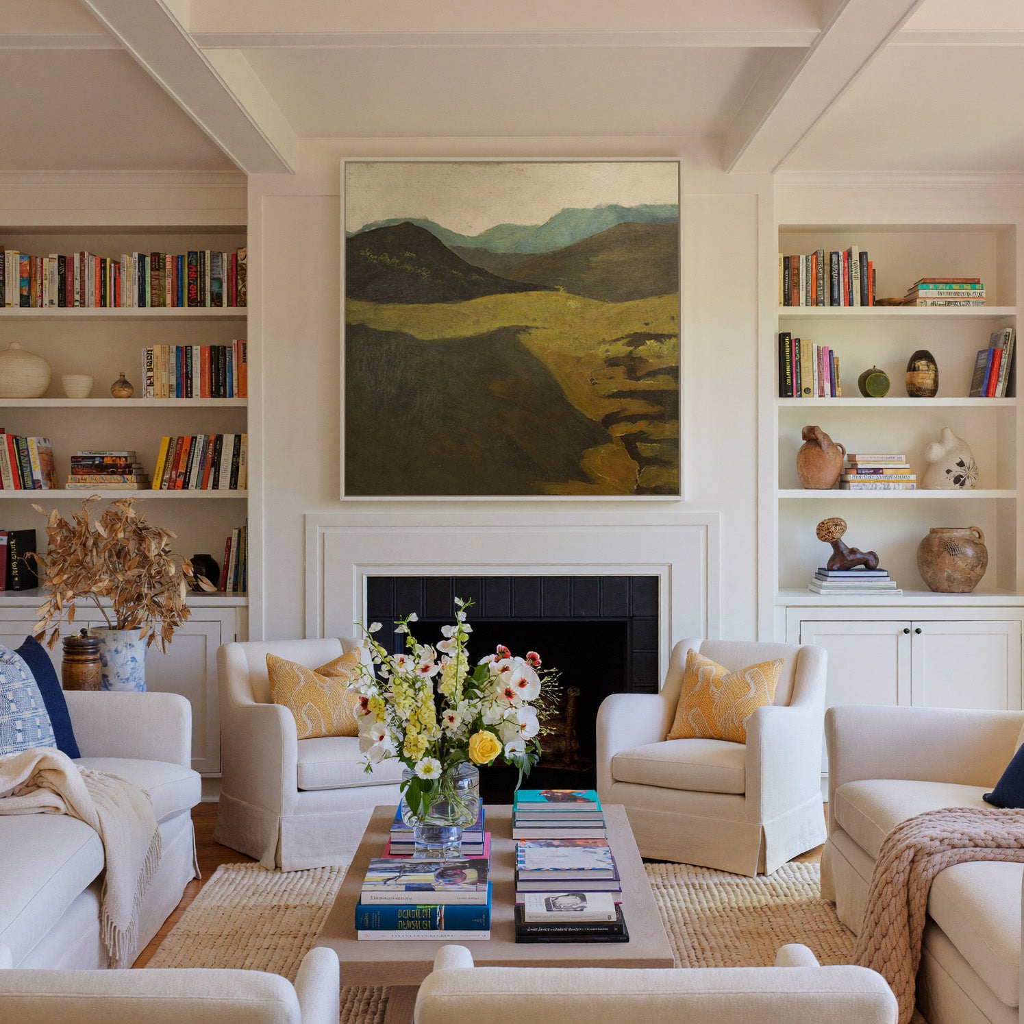 muted mountain landscape with dark foreground canvas wall art in a white frame above a fireplace