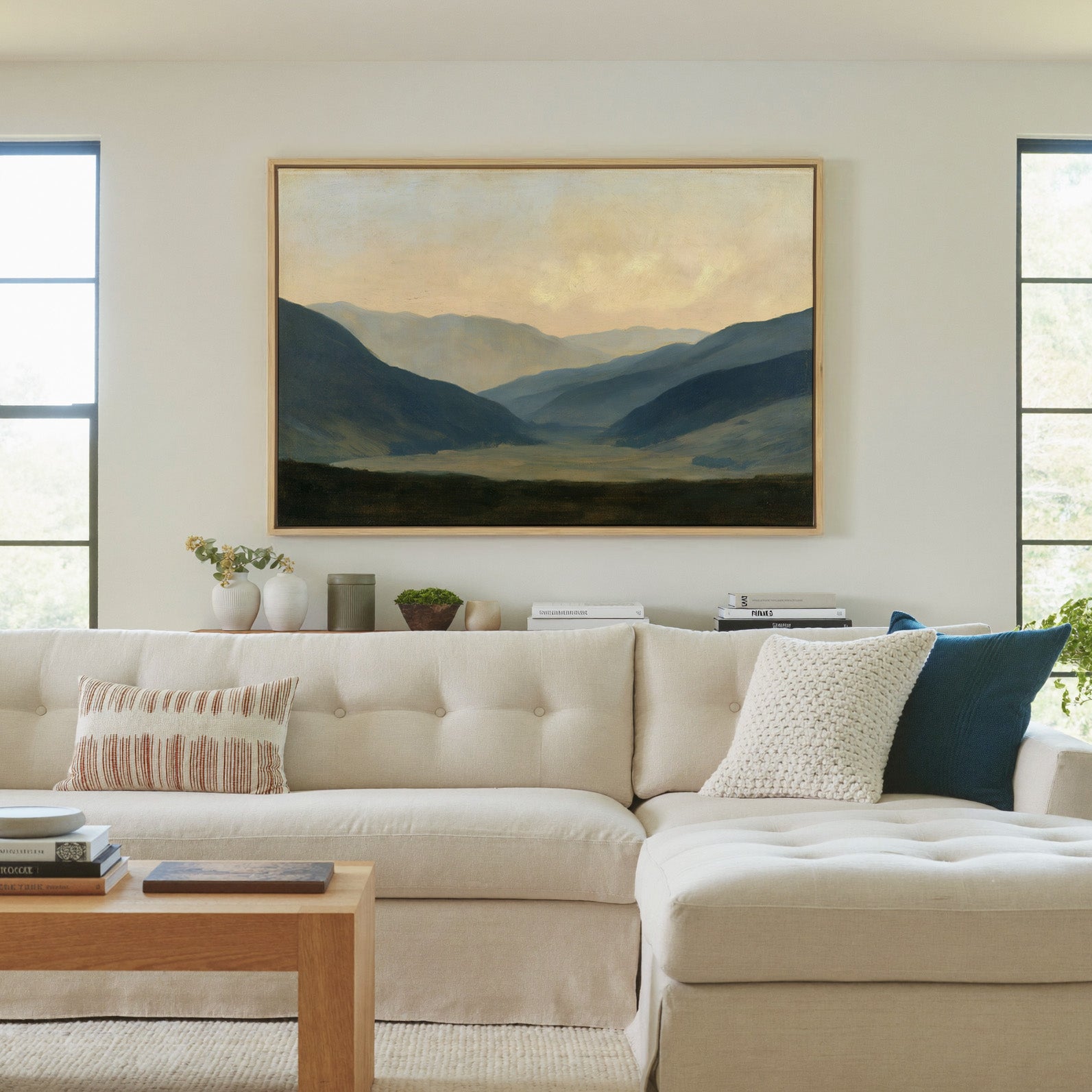 soft blue mountain valley at dawn canvas wall art in a natural wood frame in a living room
