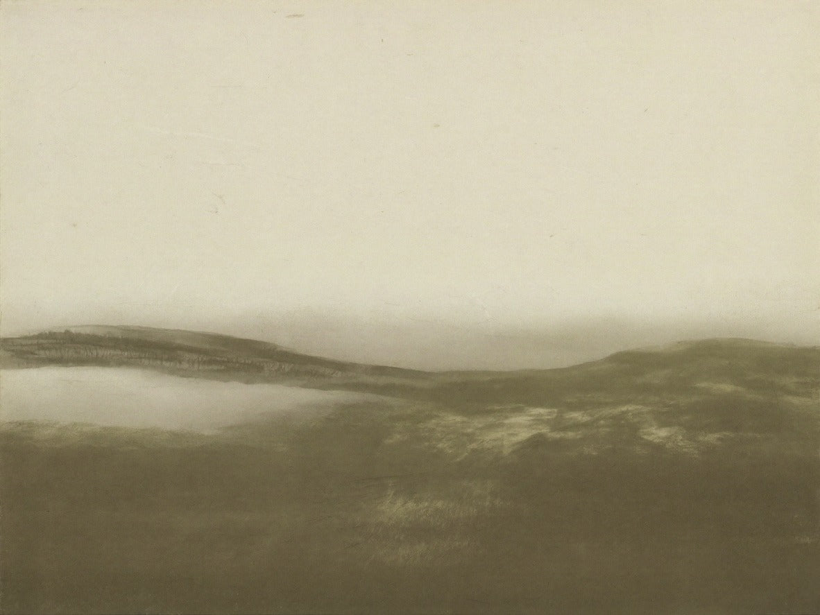 Low rolling hills in sepia olive tones beneath a pale misty sky, wide and open