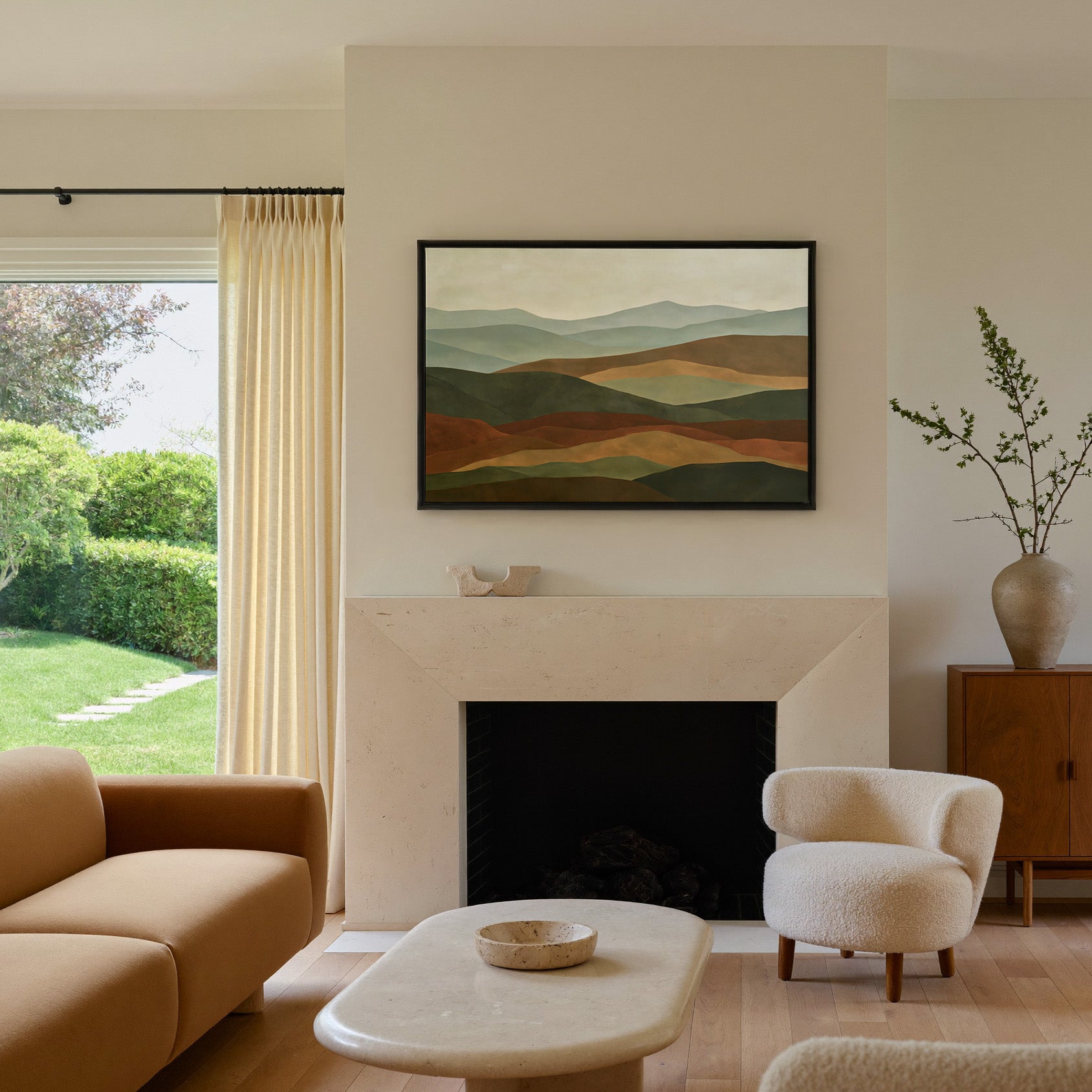 layered hills in sage, olive, rust, and tan canvas wall art in a black frame above a mantel
