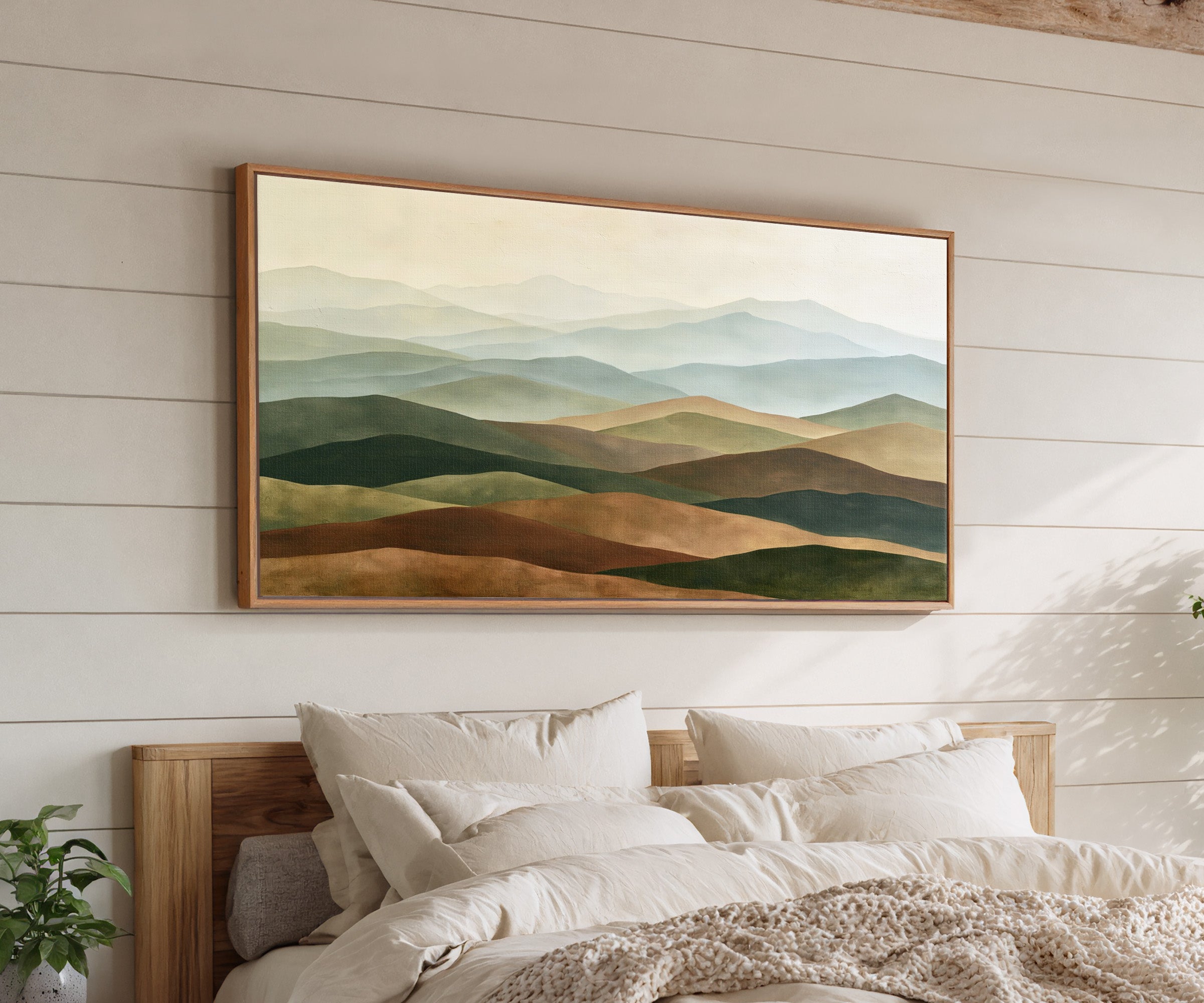 layered rolling hills in sage, blue gray, tan, canvas wall art in an oak frame above a bed