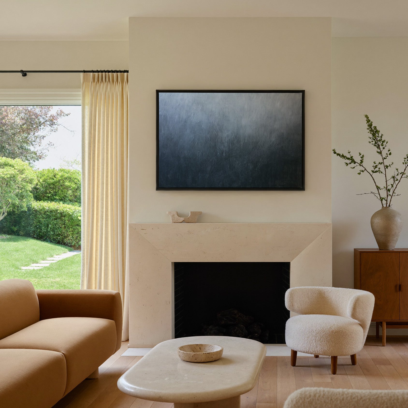 cool blue gray abstract with soft vertical canvas wall art in a black frame above a mantel