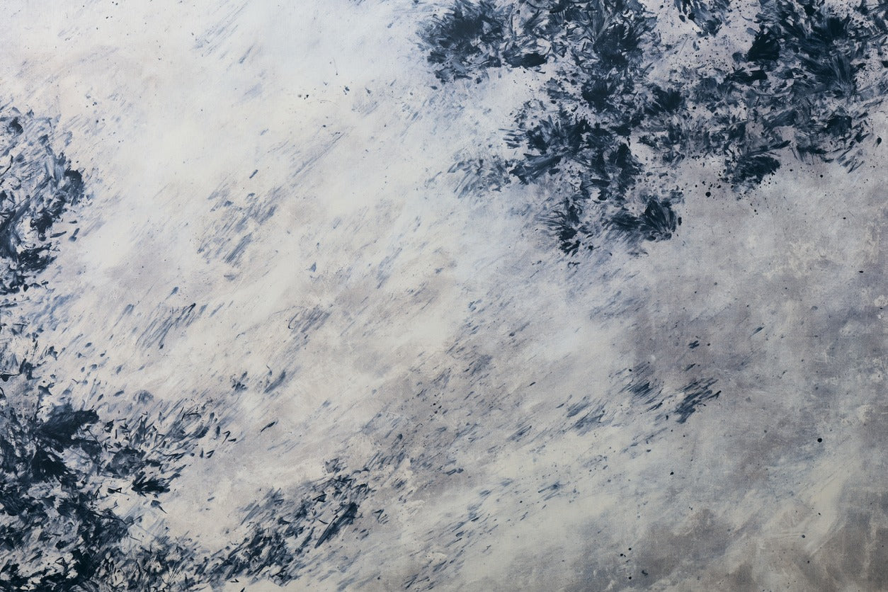 Clustered black and navy marks with diagonal gray streaks across a pale abstract field