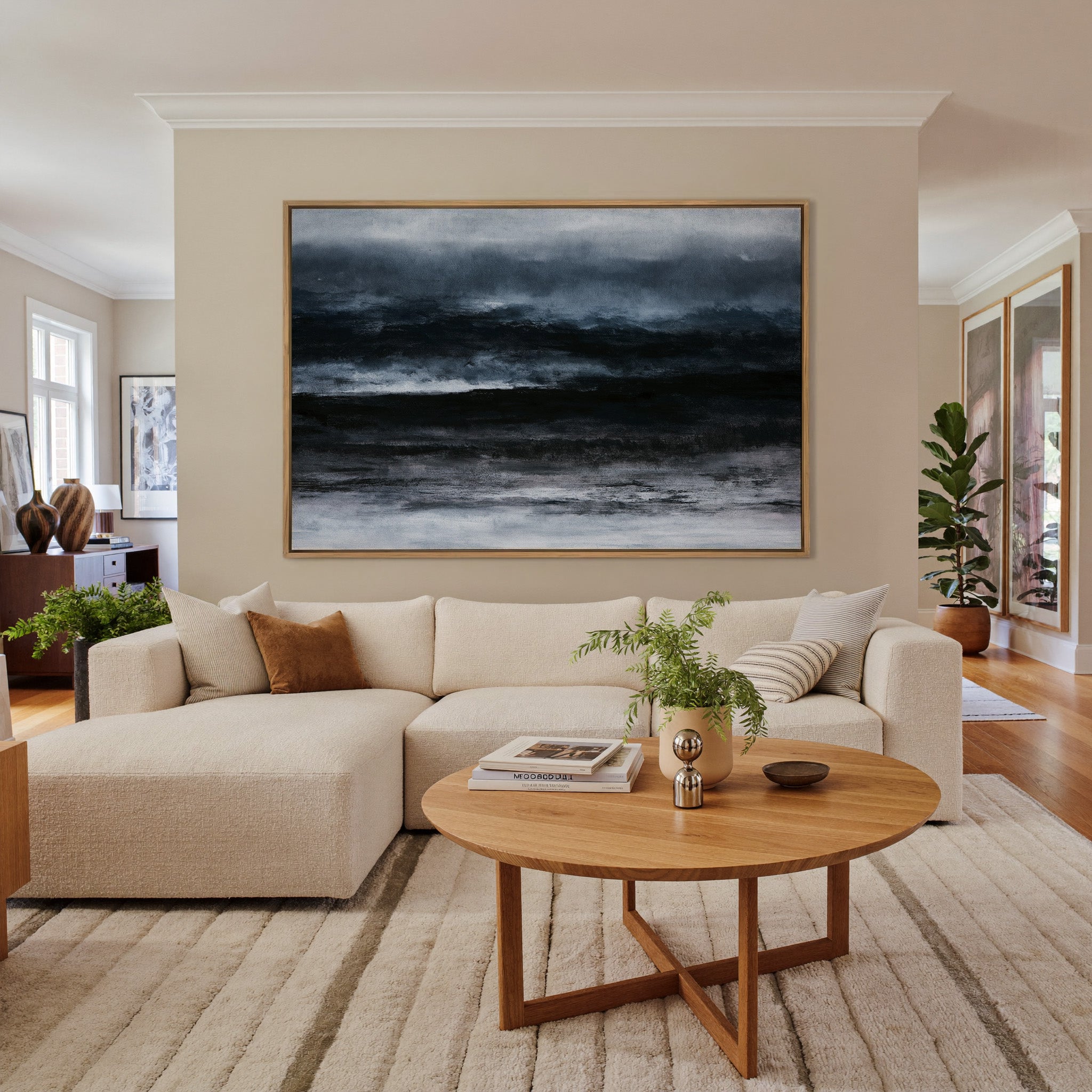 dark black and navy abstract with layered canvas wall art in an oak frame in a living room