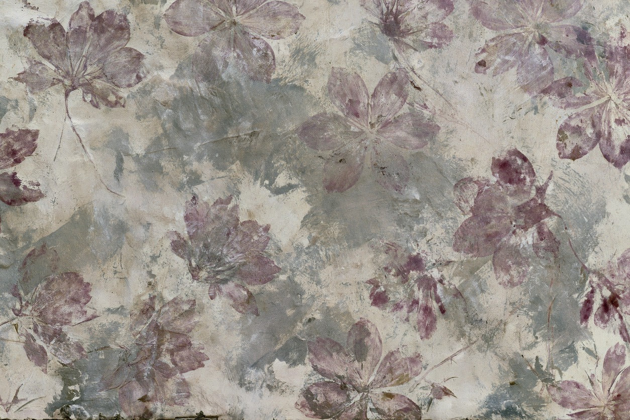 Mauve blossoms scattered across a weathered cream ground with soft gray layers and faded edges