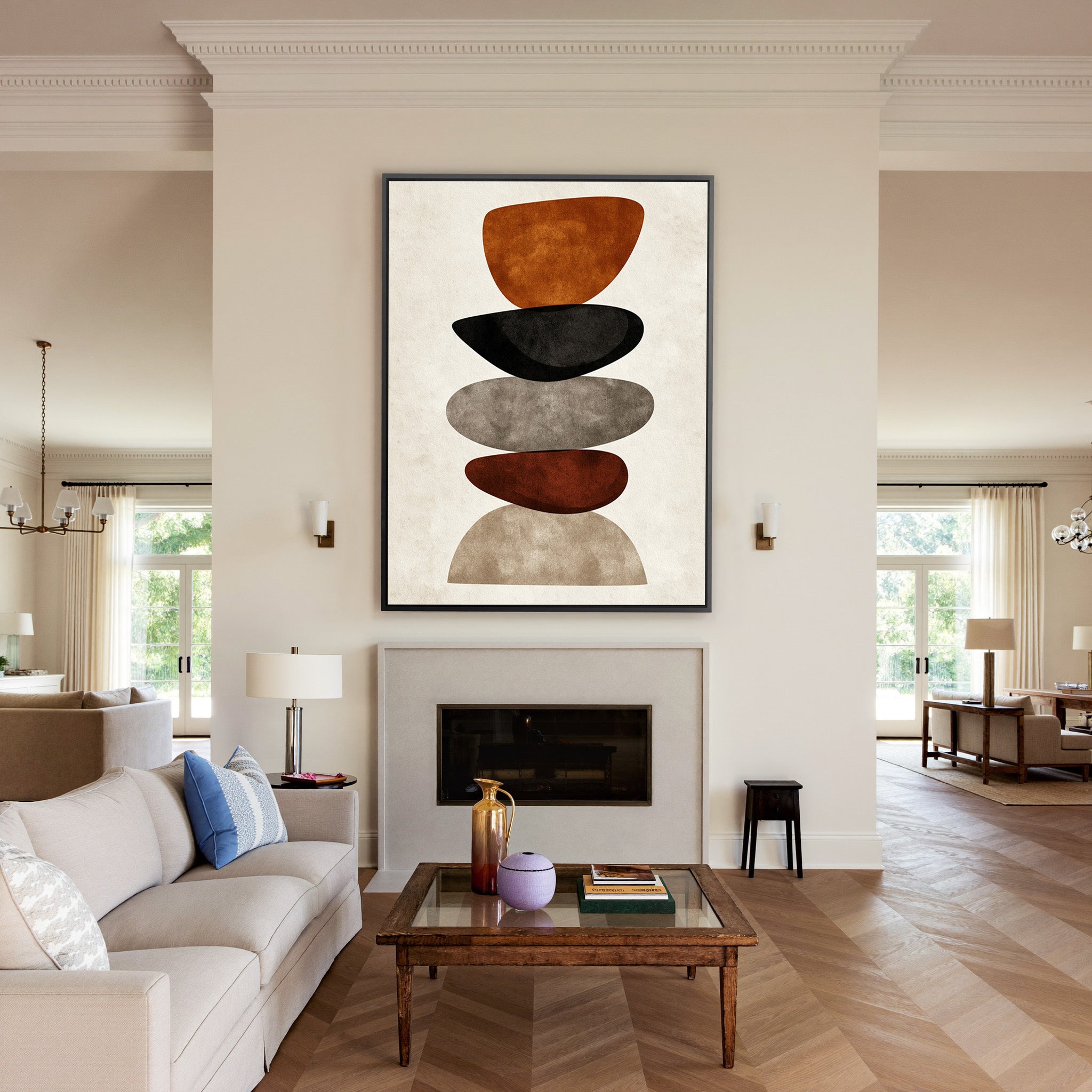 stacked organic shapes in rust, black, taupe, canvas wall art in a black frame above a mantel