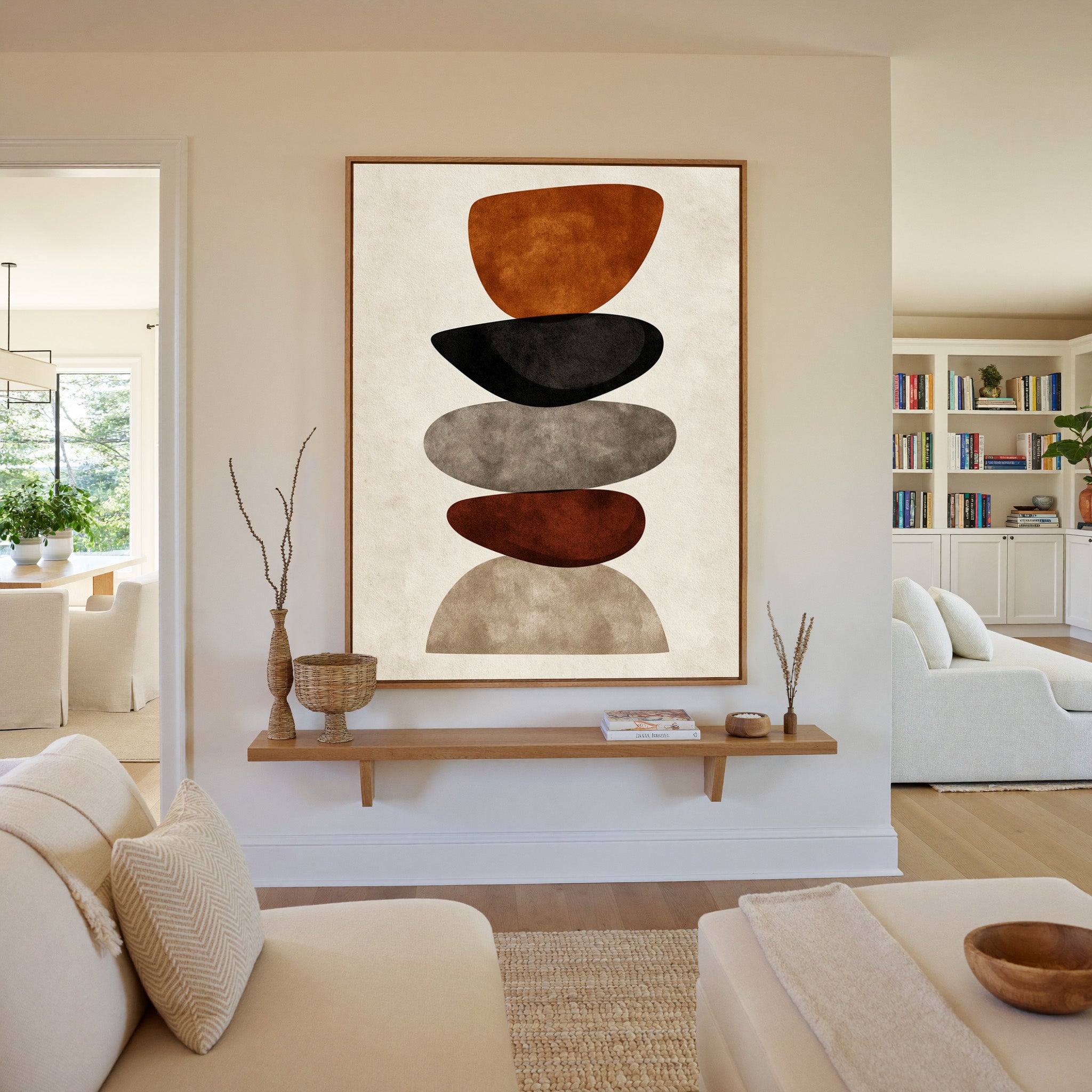 stacked organic shapes in rust, black, taupe, canvas wall art in an oak frame in a living room