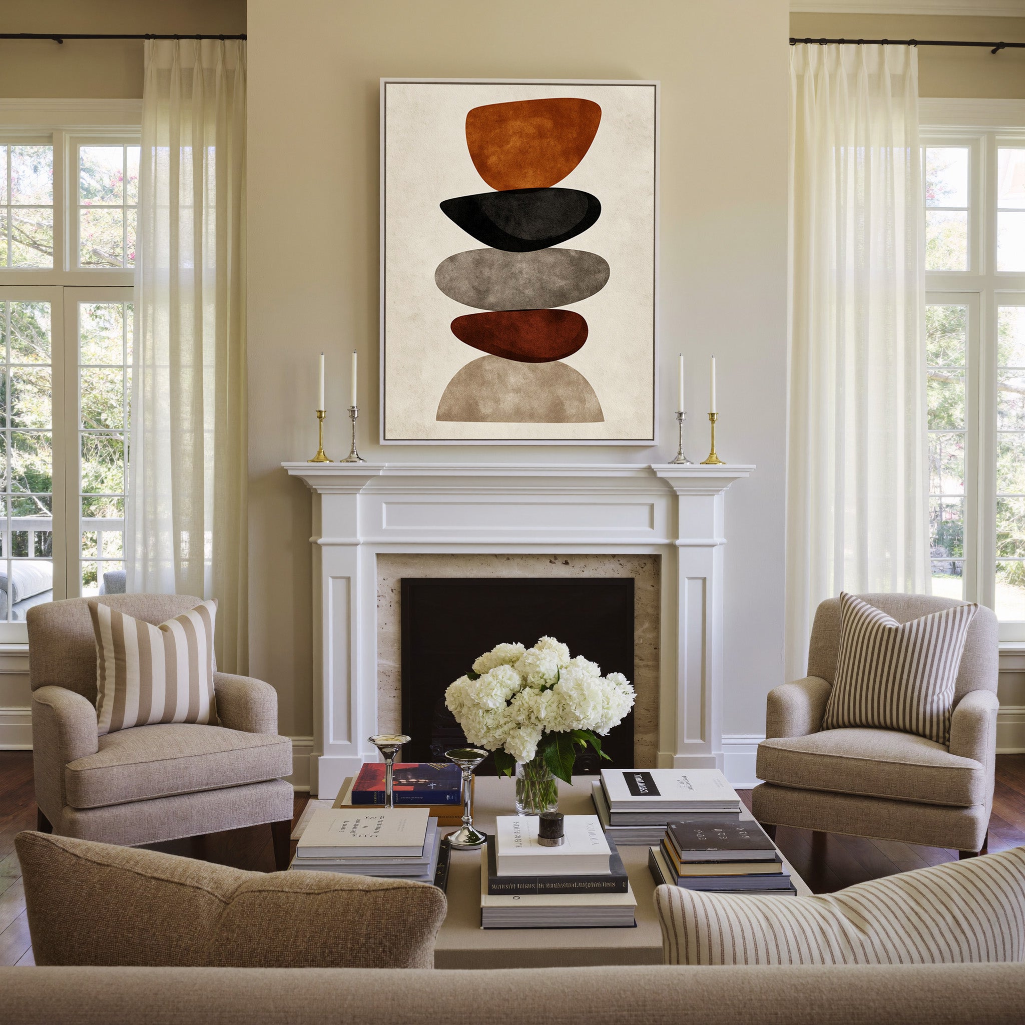stacked organic shapes in rust, black, taupe, canvas wall art in a white frame above a mantel