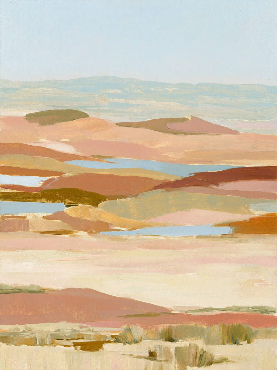 Layered desert hills in blush, sand, blue, and olive beneath a pale open sky