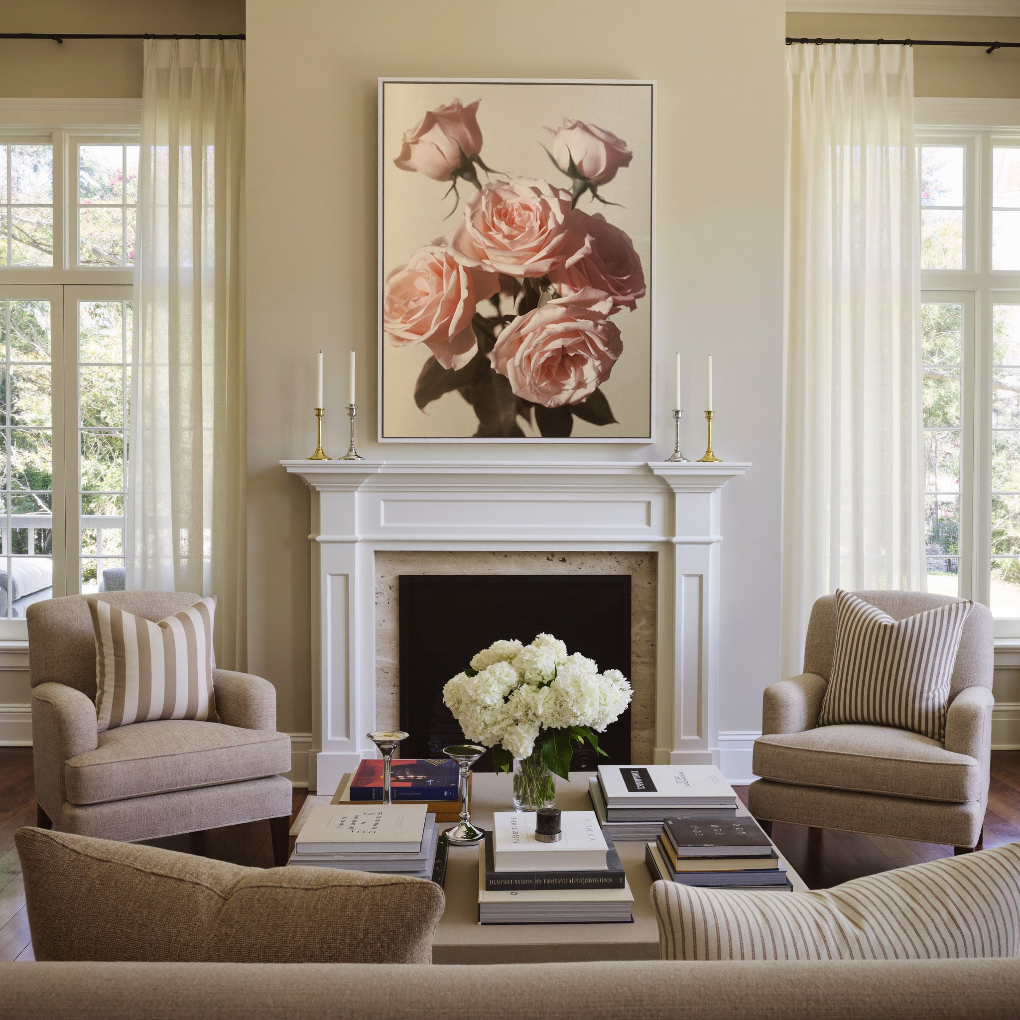 soft pink roses with dark leaves on a pale canvas wall art in a white frame above a mantel