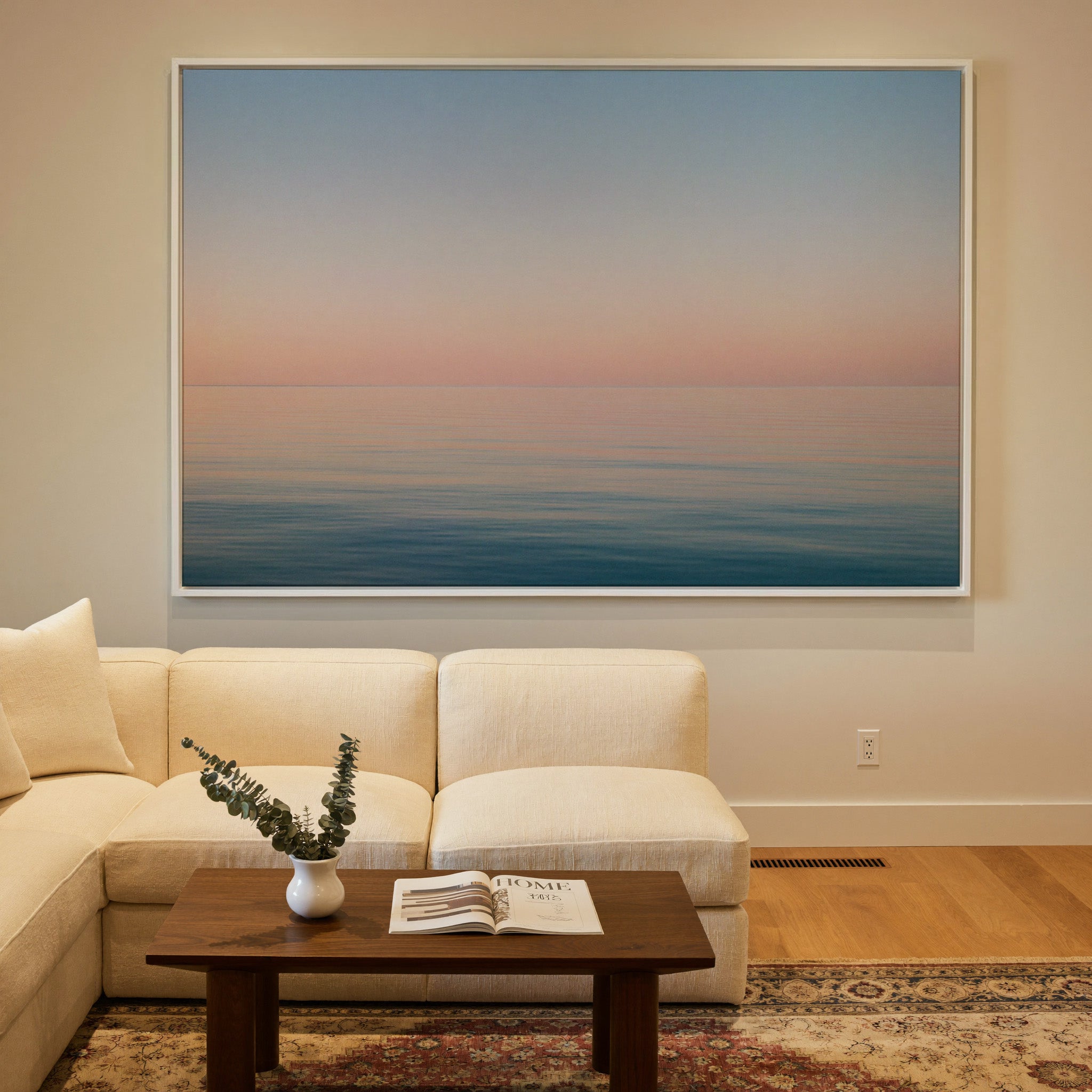 soft pastel sea and sky seascape canvas wall art in a white frame in a styled room setting