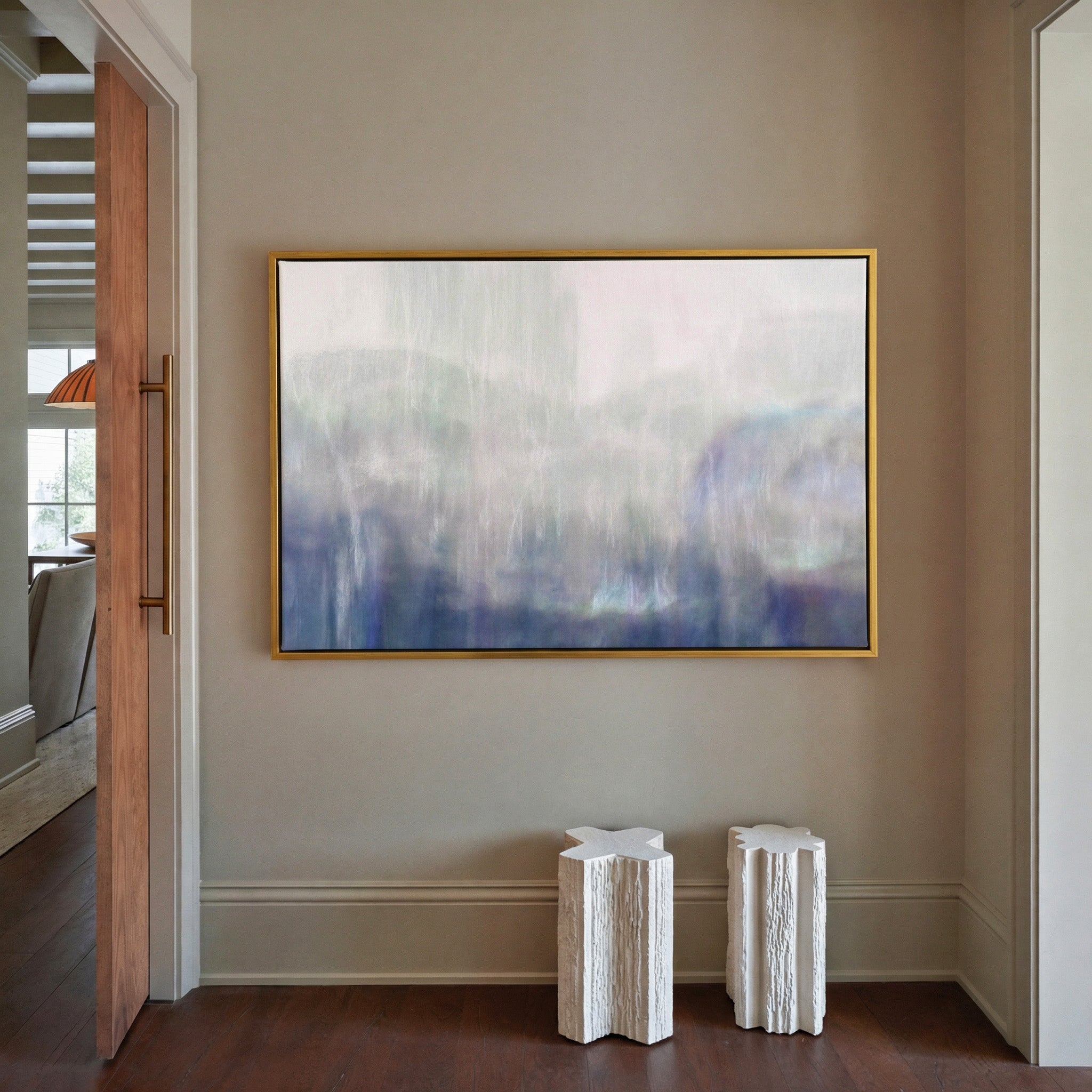 soft blue and violet abstract canvas wall art in a gold frame in a styled room setting