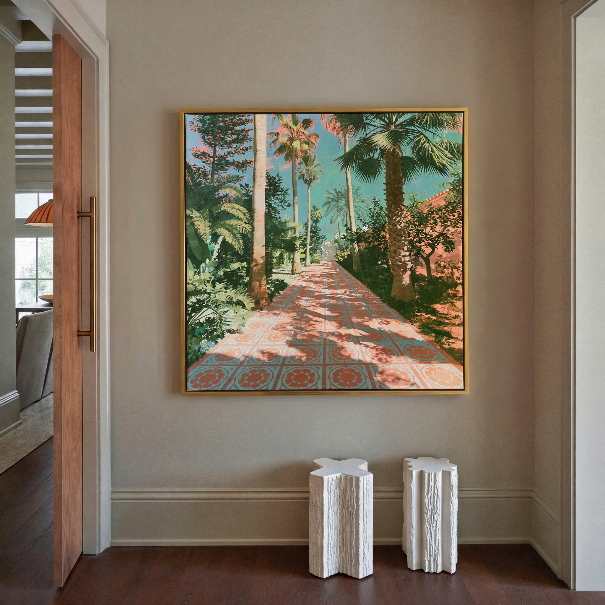 tall palms and patterned terracotta paving canvas wall art in a gold frame in a styled room setting