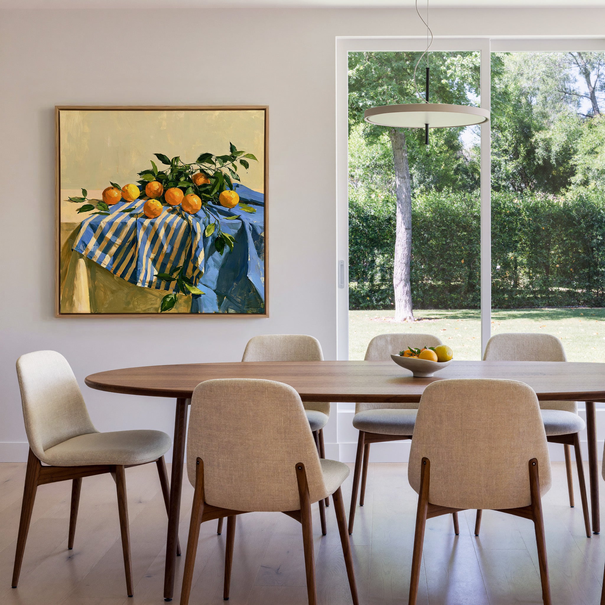 oranges on a blue striped cloth canvas wall art in an oak frame in a dining room