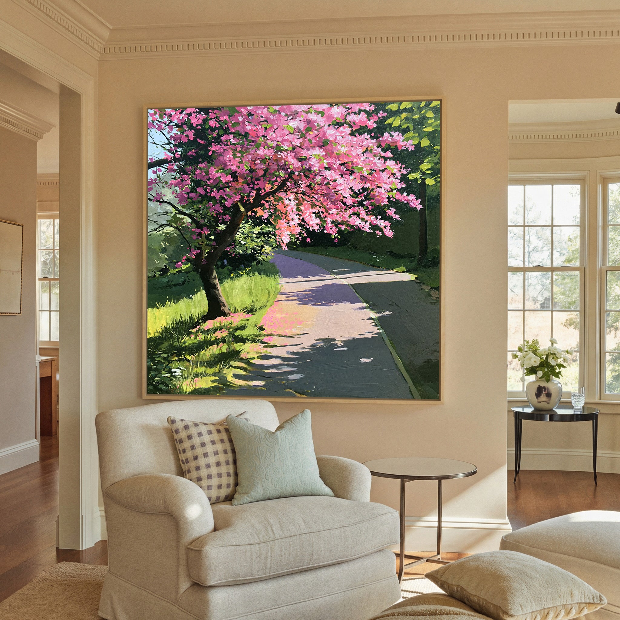 pink flowering tree beside a curving path canvas wall art in a natural wood frame in a styled room setting