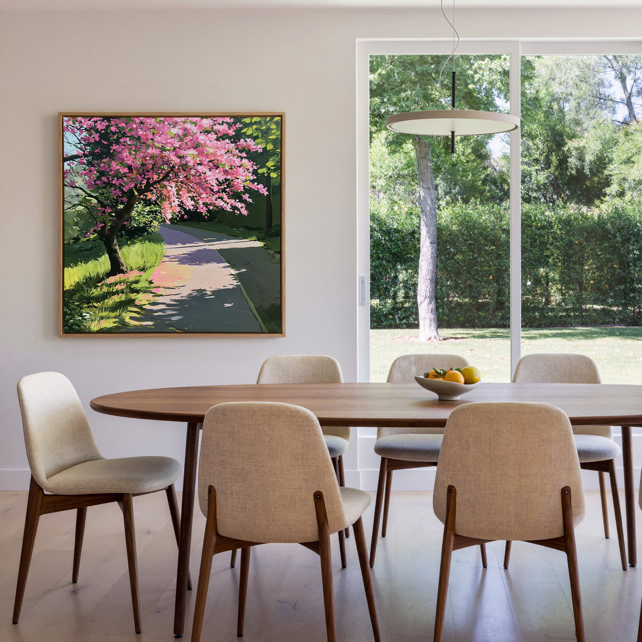 pink flowering tree beside a curving path canvas wall art in an oak frame in a dining room