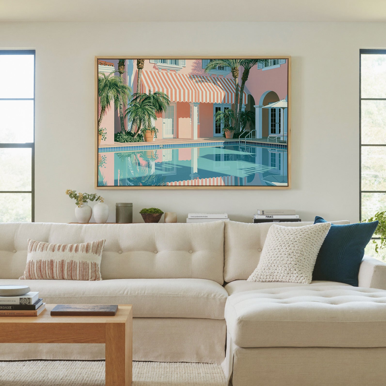 pastel courtyard with striped awning and palms canvas wall art in a natural wood frame in a living room