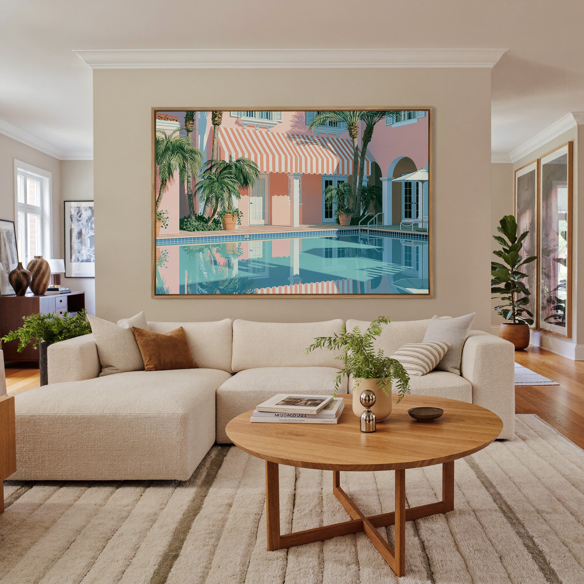 pastel courtyard with striped awning and palms canvas wall art in an oak frame in a living room