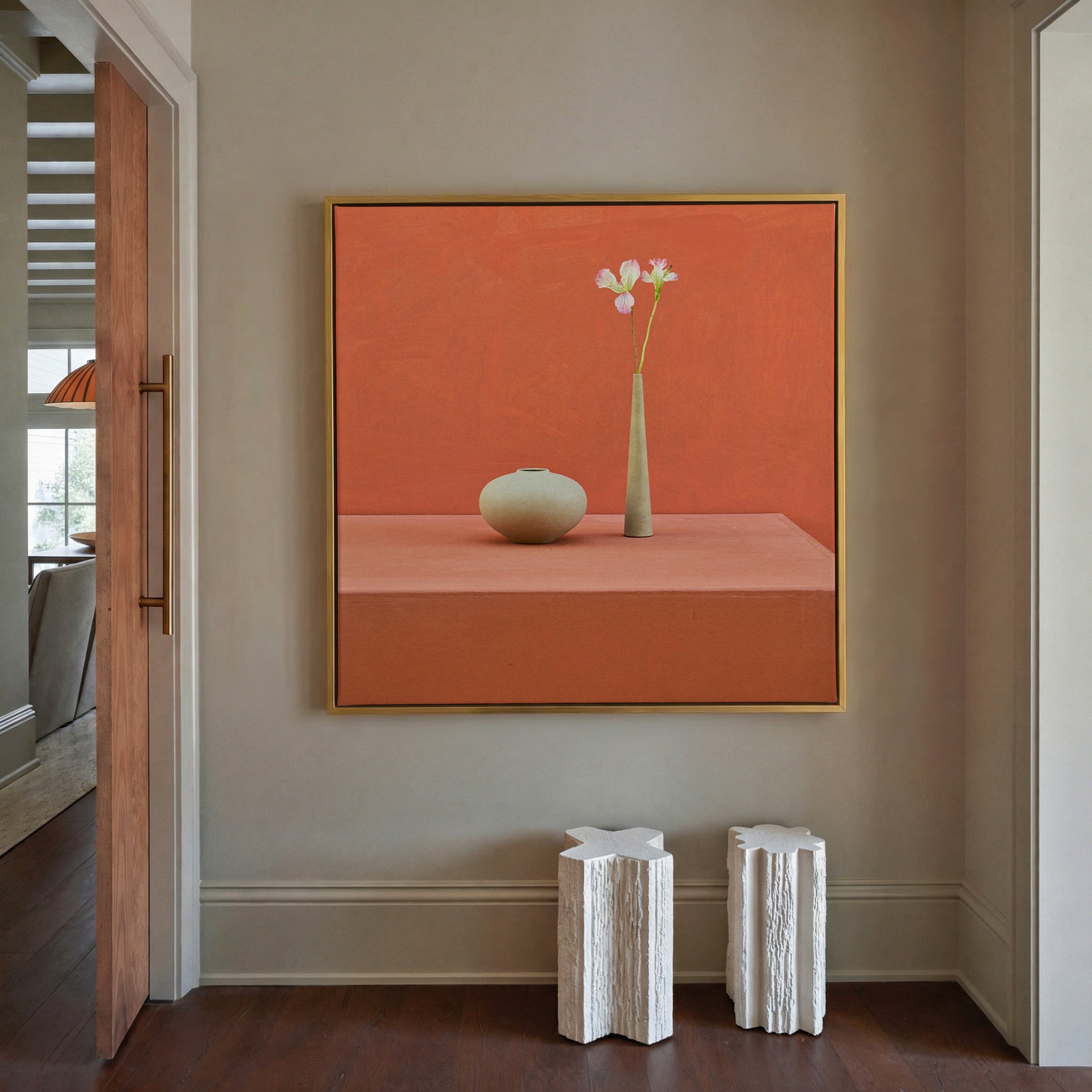 terracotta still life with vase and single stem canvas wall art in a gold frame in a styled room setting